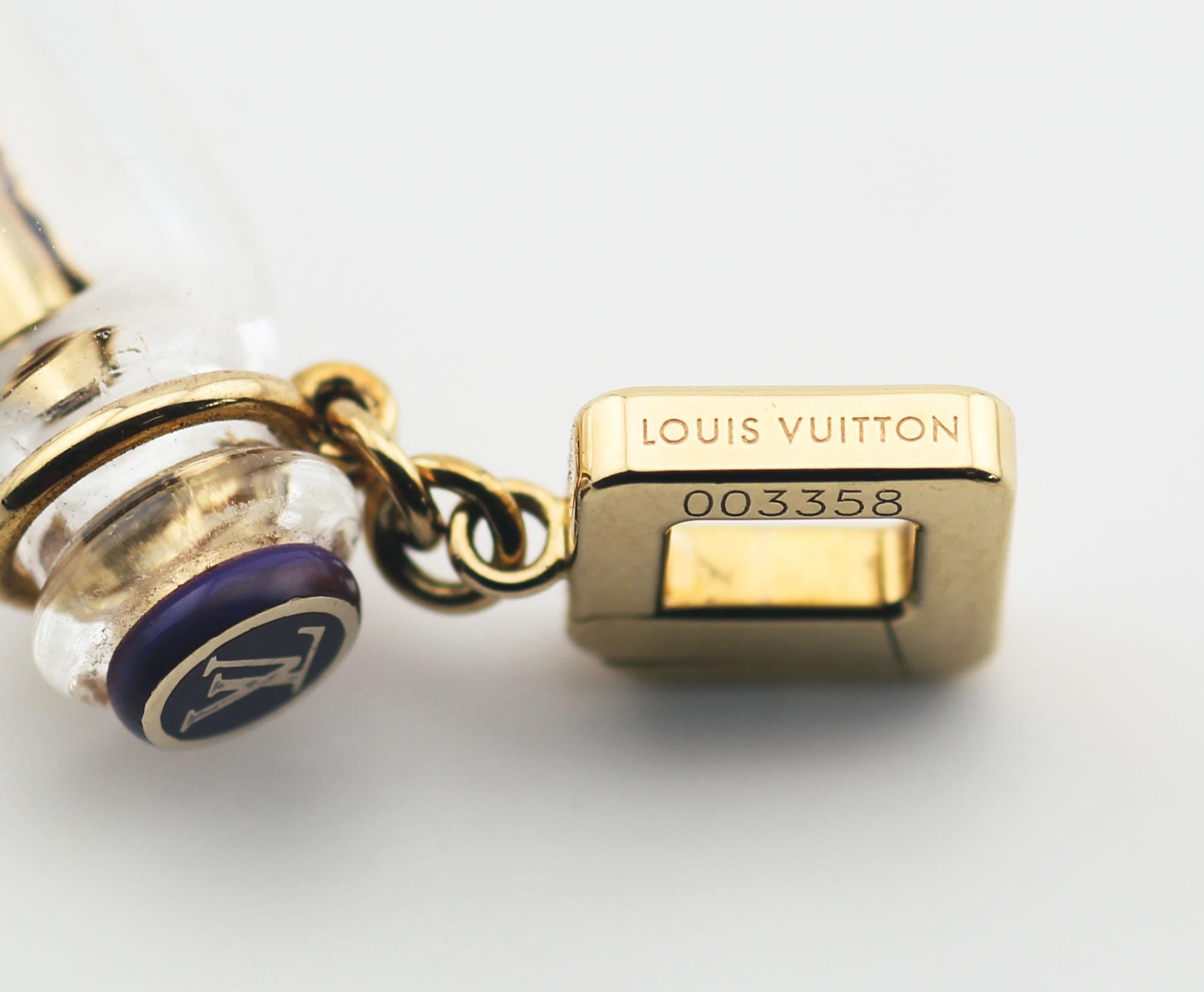 The Louis Vuitton Enamel 18K Yellow Gold Love Message in Bottle Charm Pendant is a captivating piece that blends luxury with sentimentality. This charm is crafted in lustrous 18k yellow gold, showcasing the brand's renowned craftsmanship and