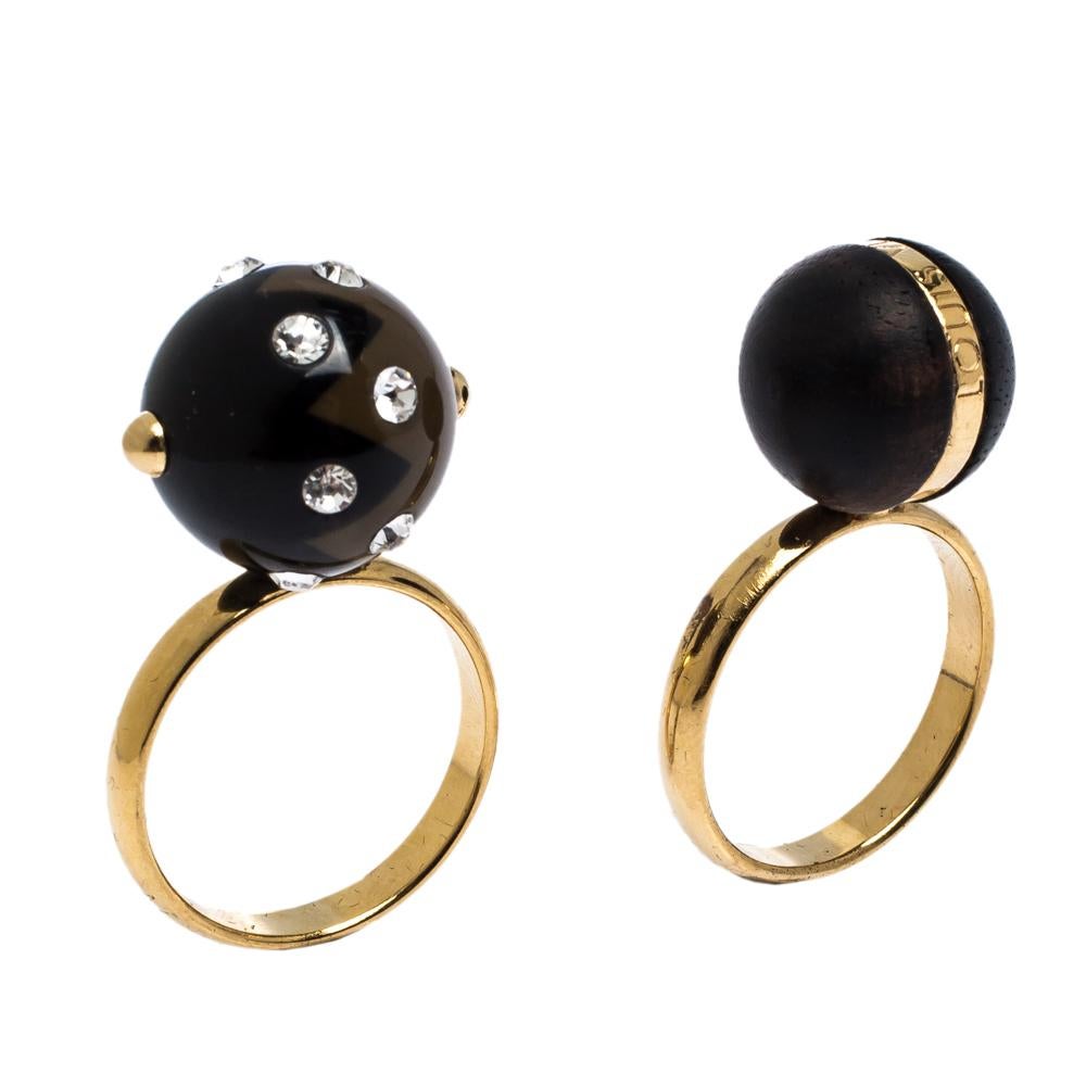 Sculpted with beauty in mind, this set of rings from Louis Vuitton will bring you countless days of charm. The rings are made from gold-tone metal and feature wooden balls on the head. One of the balls is adorned with crystal embellishments while