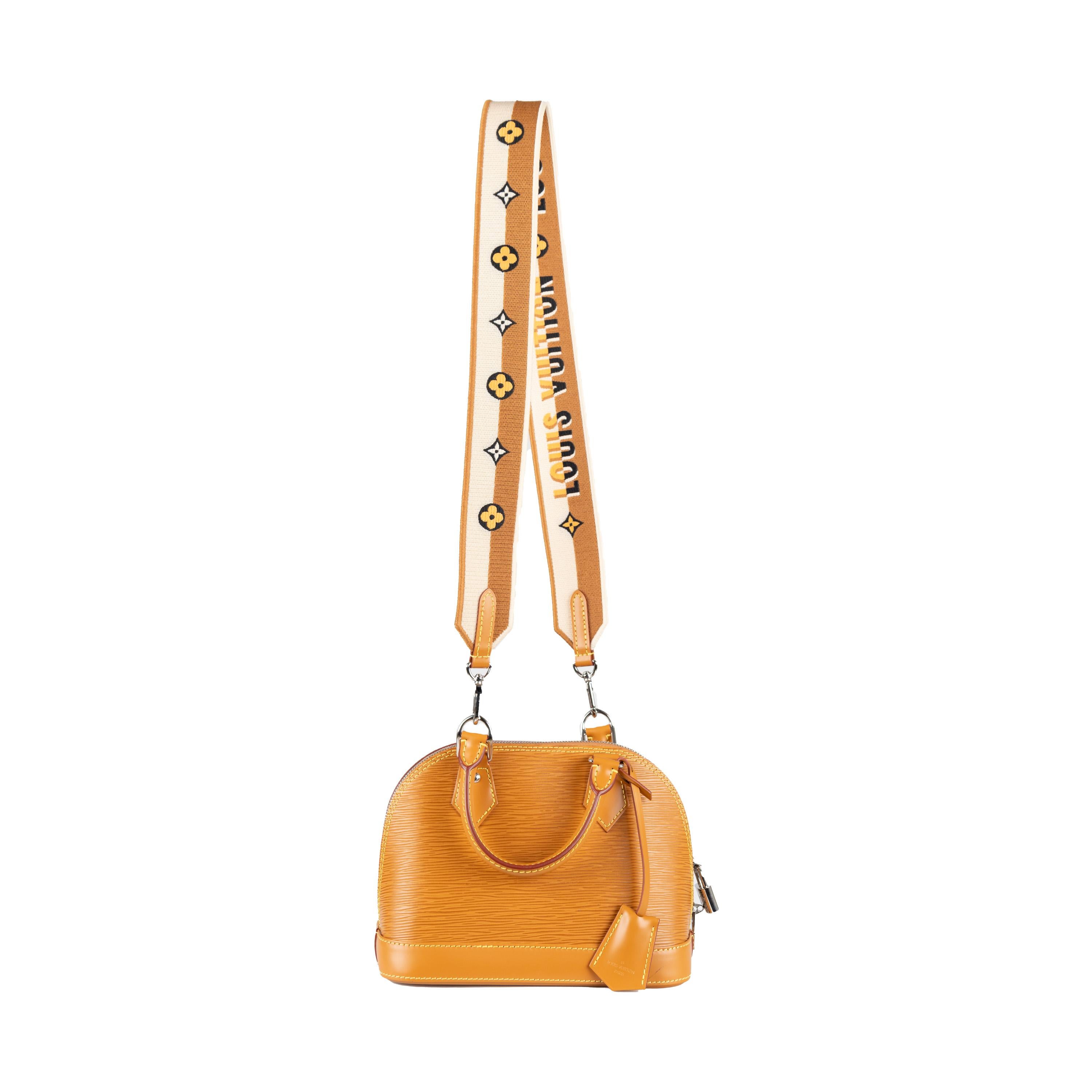 The Louis Vuitton Epi Alma BB Handbag is exquisitely crafted in signature epi leather with texture. The honey gold exterior is complemented by cowhide rolled leather top handles and a detachable shoulder strap for convenient portability. Crafted