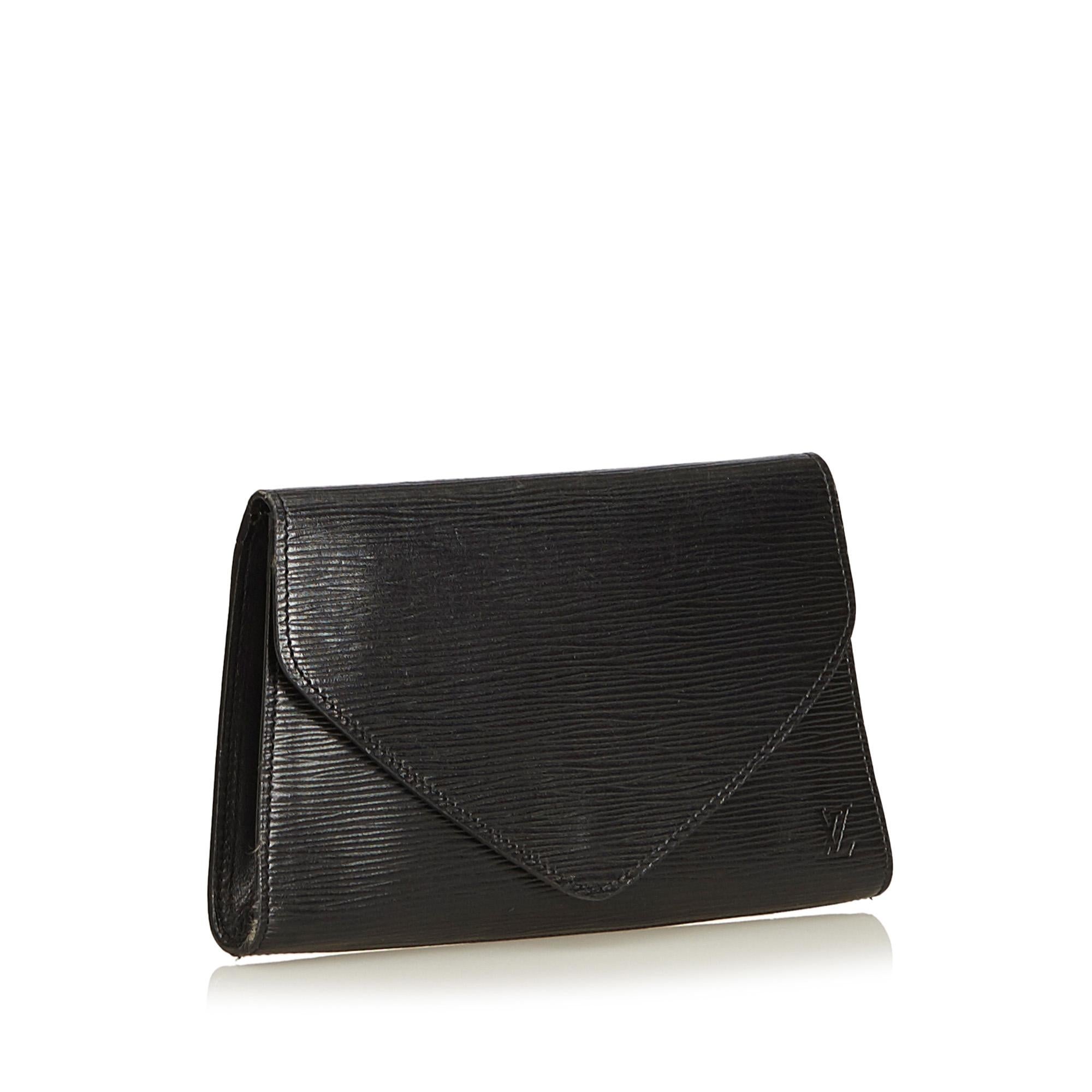 The Louis Vuitton Art Deco Clutch is an envelope clutch and features a black epi leather body, front flap with snap closure, single exterior back pocket, and an interior slip pocket. 

Serial number: 881VI