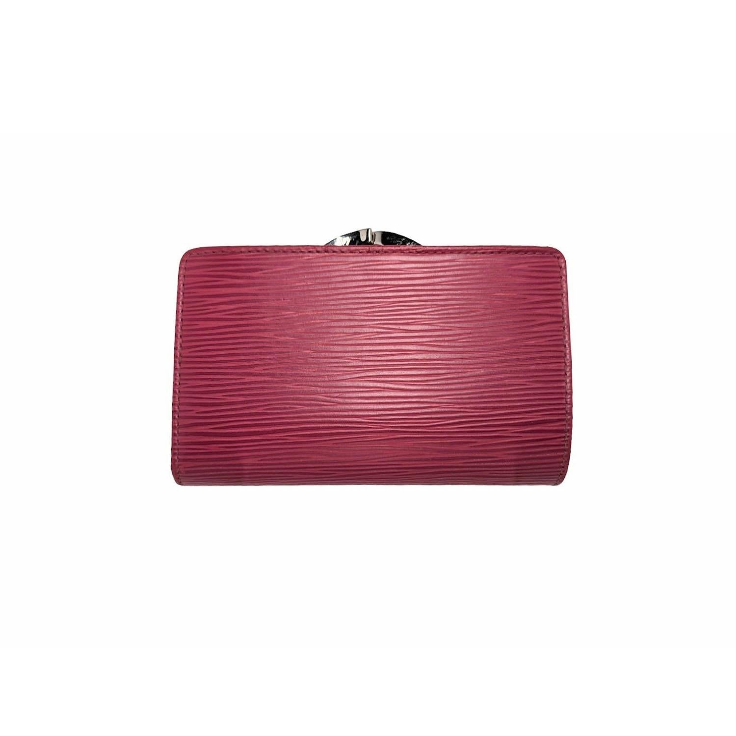 Louis Vuitton Epi French Purse Wallet in Castillan Red. This stylish clutch wallet is finely crafted of Louis Vuitton signature textured epi leather in bright red. The wallet opens to a cross-grain red leather interior with card slots, patch