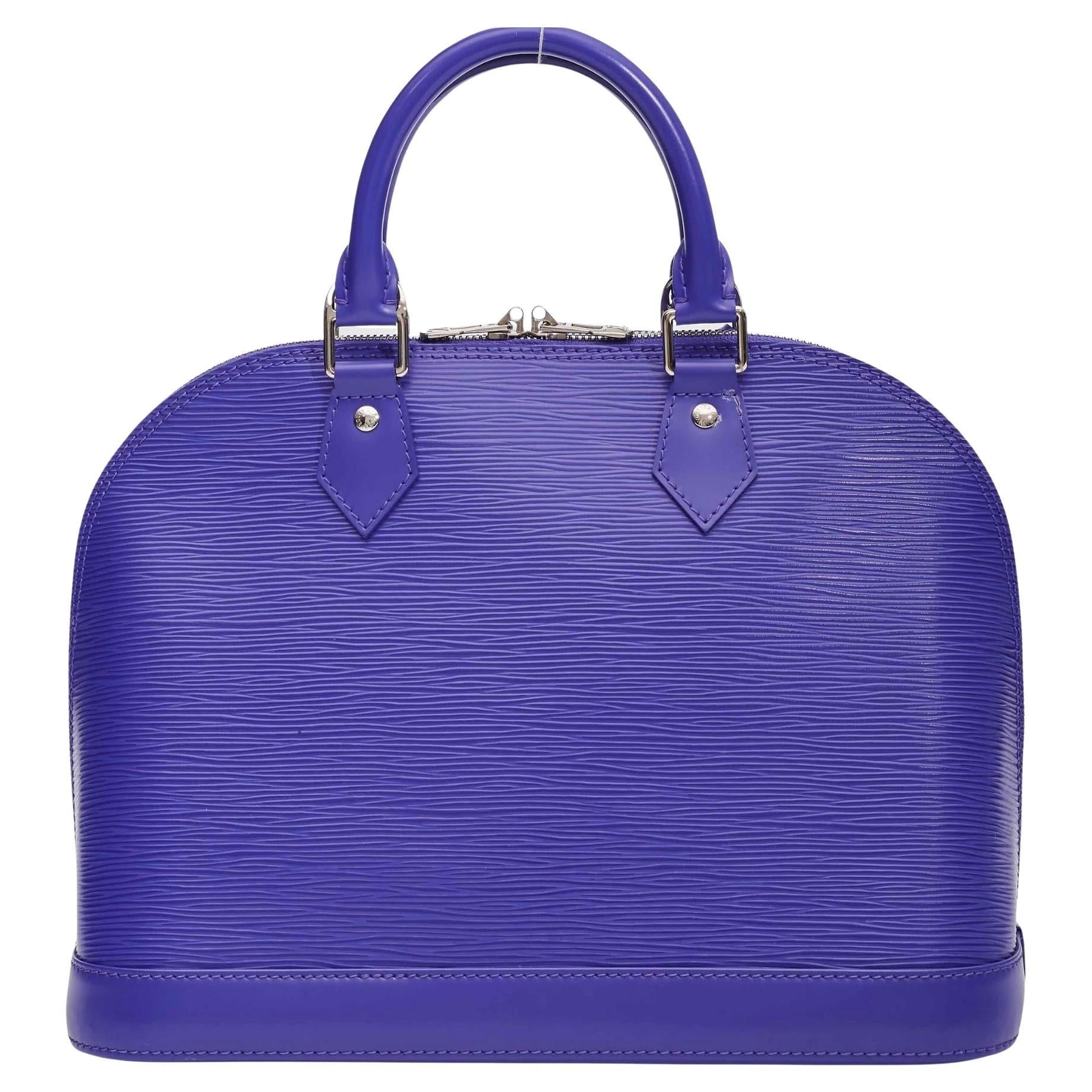 The Alma PM features an epi leather body, rolled handles, a top zip closure, and an interior slip pocket. It carries a A Condition Rating

Color: Purple
Material: Epi leather
Date code: FL3152
Year: 2012
Measures: Height 9” x Length 12” x Depth