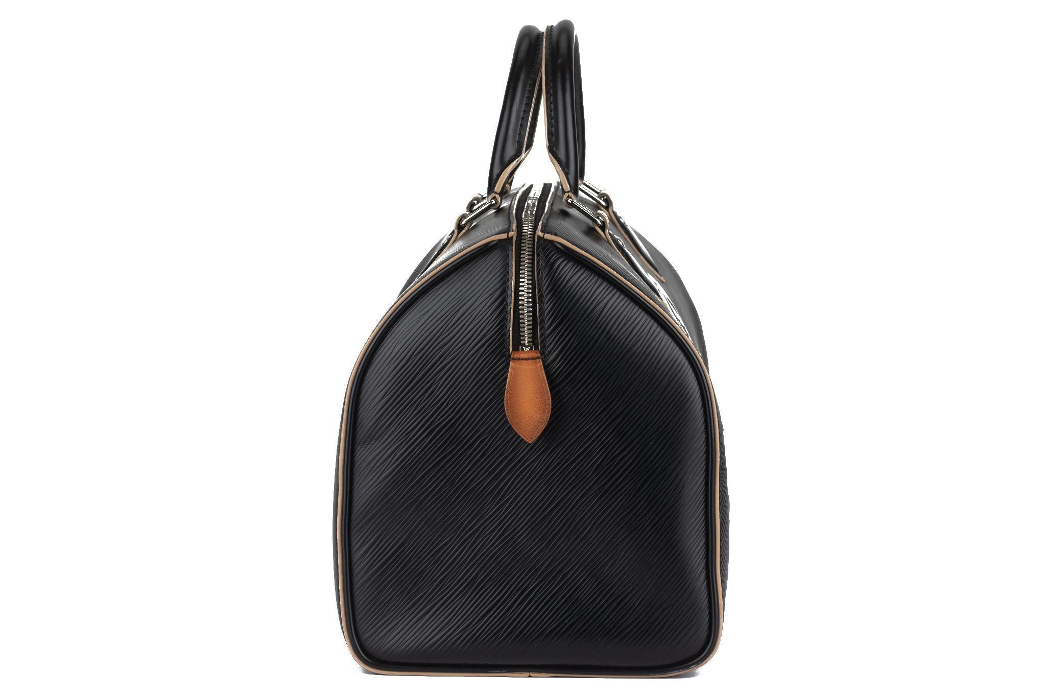 This Louis Vuitton Epi World Tour Speedy 30 in Black. This stylish tote is finely crafted of Louis Vuitton's signature textured epi leather in black, with travel patches embossed throughout. This bag features rolled leather top handles and polished
