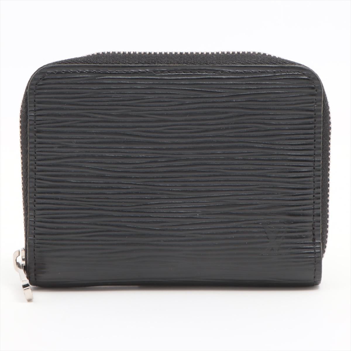 The Louis Vuitton Epi Zippy Coin Purse in Black is a refined and compact accessory that effortlessly blends luxury with functionality. Crafted from the iconic Epi leather, known for its distinctive texture and durability, the coin purse exudes