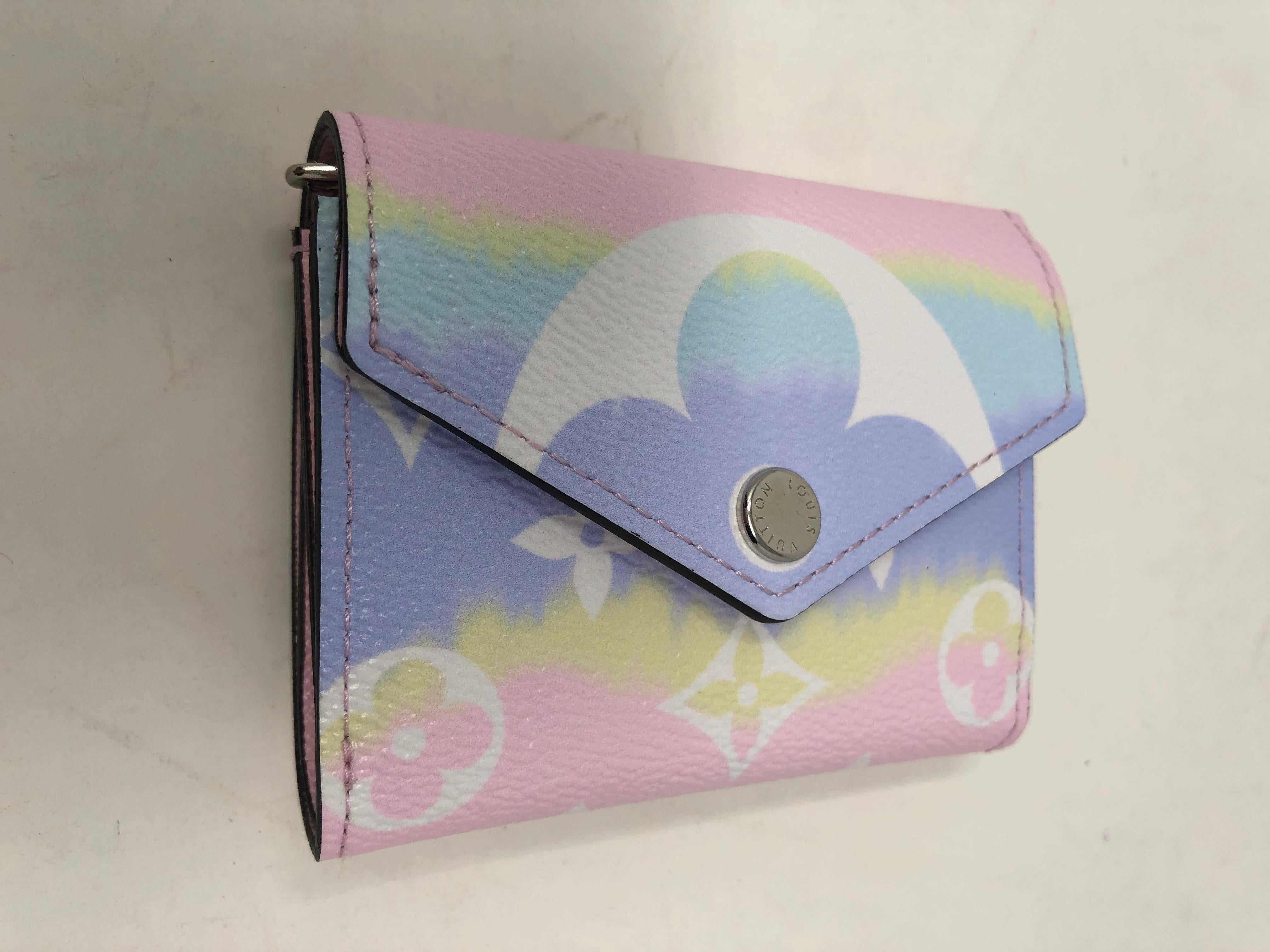 Louis Vuitton Escale Pink Zoe Wallet. Compact small wallet in pretty pastel shades. Sold out collection. Limited in production. Brand new in box with dust cover. The look for this collection was inspired by Japanese shibori tie- dyeing process. Hard