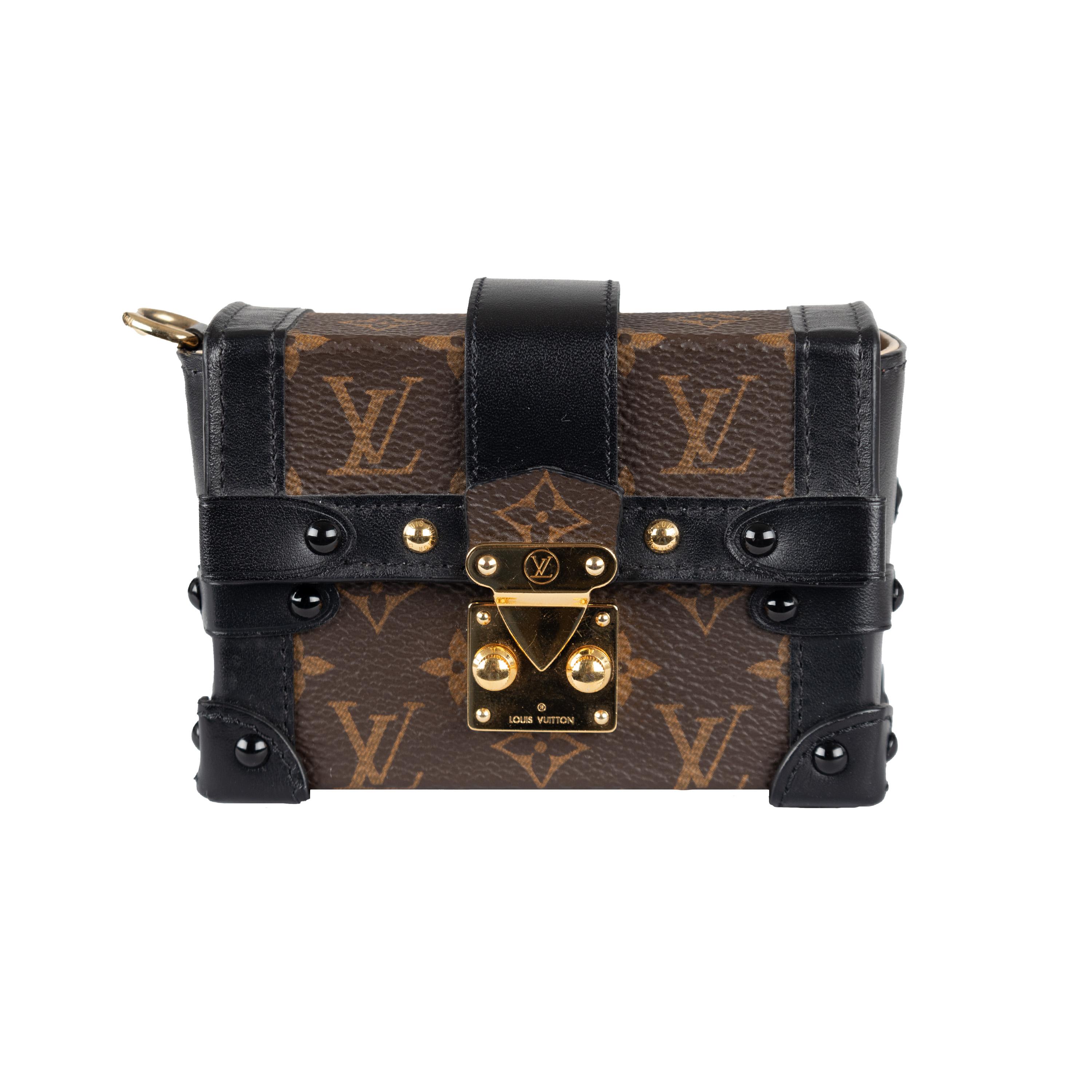 This Louis Vuitton Essential Trunk Mini Bag is crafted with Monogram Canvas and Trunk detailing on the edges. It features an iconic S-lock crafted in aged gold hardware and a detachable chain strap perfect for multiple uses: such as a mini clutch,