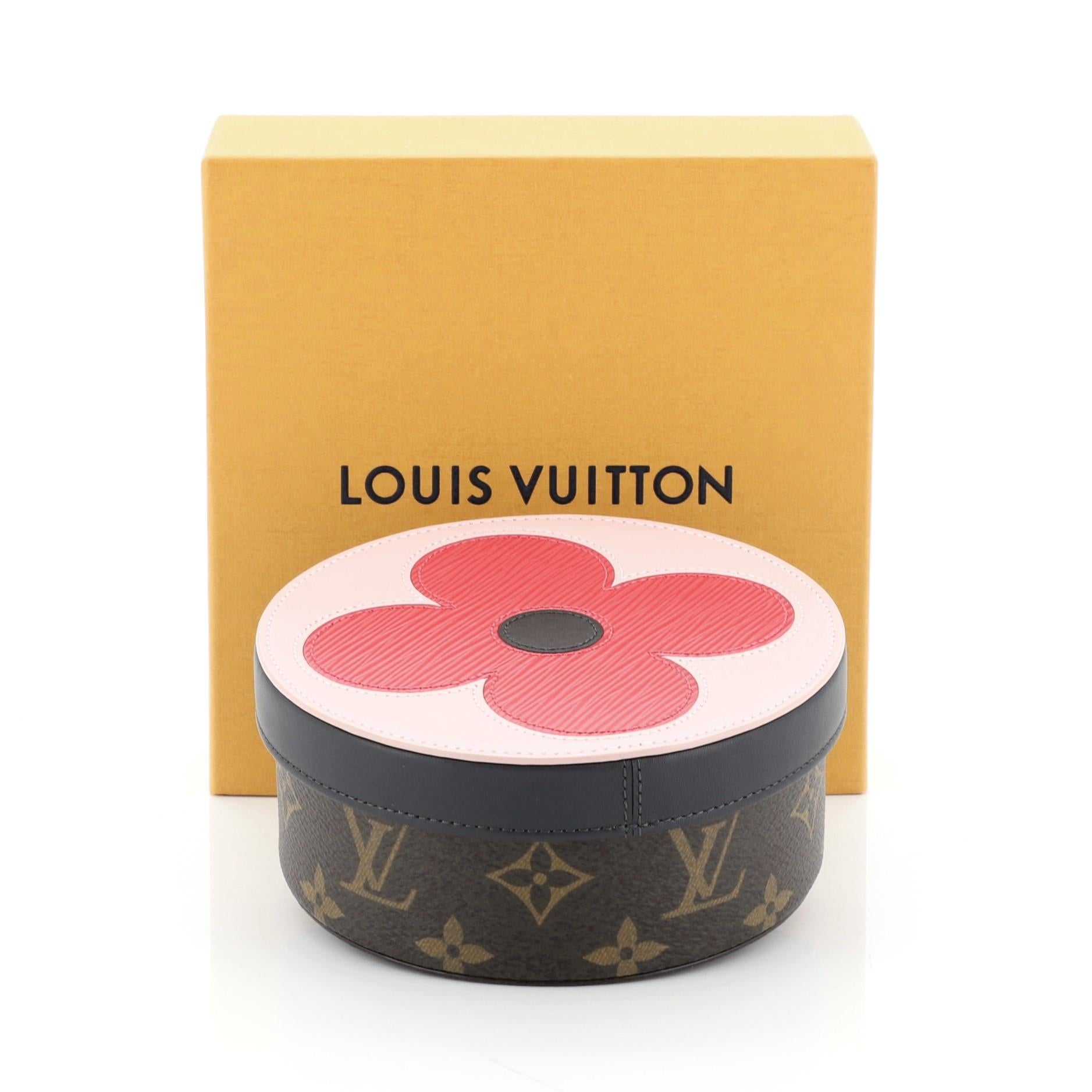 This Louis Vuitton Eugenie Box Epi Leather and Monogram Eclipse Canvas MM, crafted in brown monogram coated canvas, features top round pink epi leather monogram fleur lid. It opens to a pink microfiber interior. Authenticity code reads: UB1108