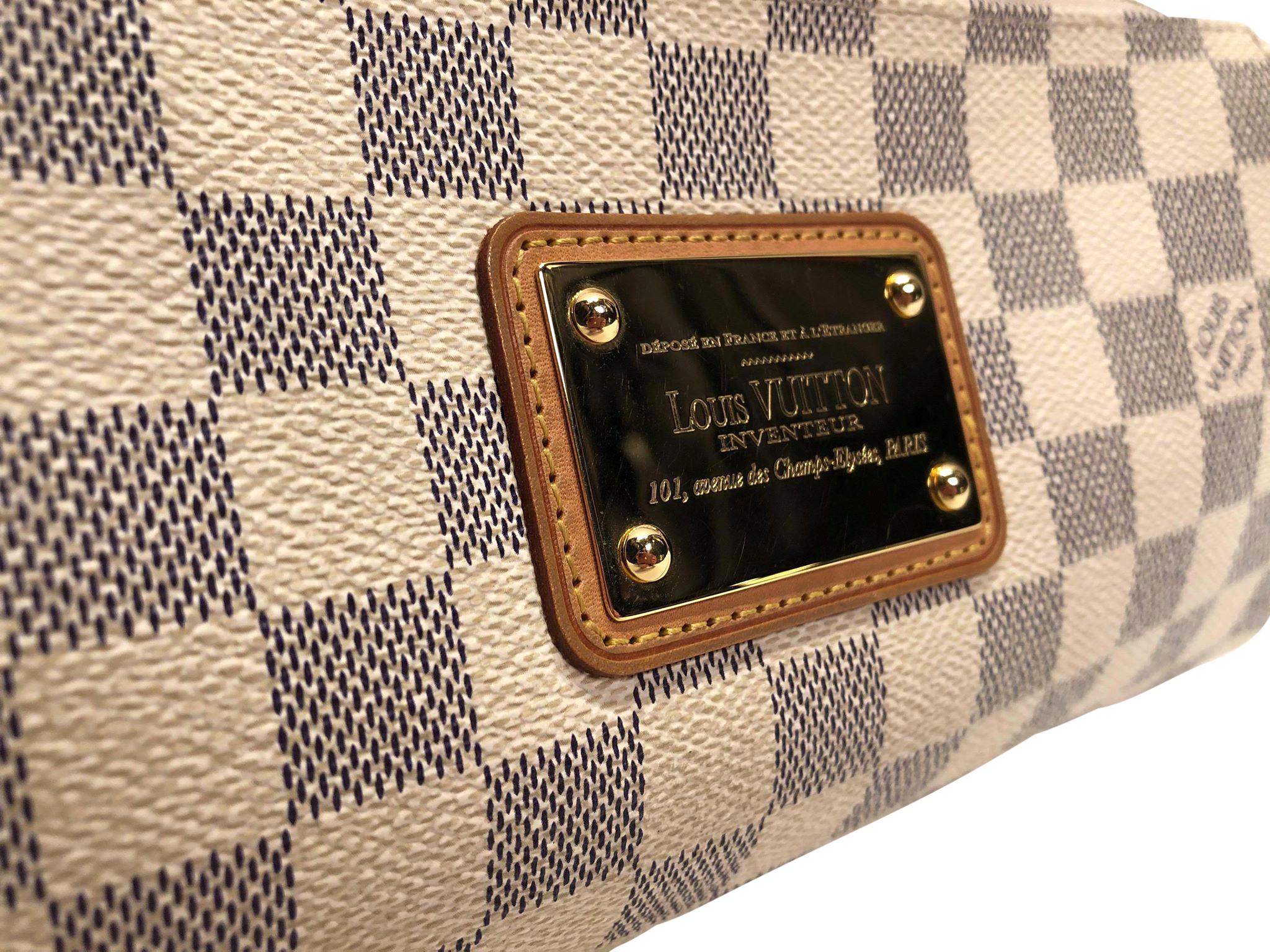 Louis Vuitton Eva Pochette in iconic Damier Azur coated canvas with beige canvas interior. This petit handbag features vachetta leather trimming, gold toned harware, including front and centre logo placard, and an optional small chain link shoulder
