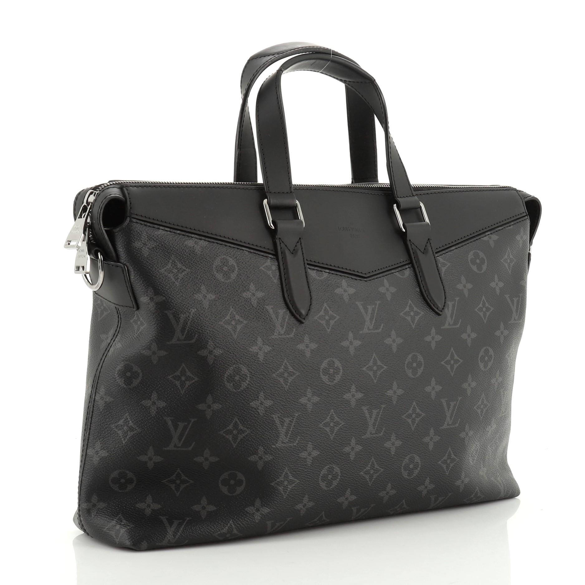 This Louis Vuitton Explorer Briefcase Monogram Eclipse Canvas, crafted in black eclipse monogram coated canvas, features dual-flat leather handles, adjustable shoulder strap, black leather trims, and gunmetal-tone hardware. Its zip closure opens to