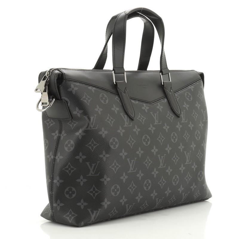This Louis Vuitton Explorer Briefcase Monogram Eclipse Canvas, crafted in black eclipse monogram coated canvas, features dual flat leather handles, leather trim, and gunmetal-tone hardware. Its zip closure opens to a black fabric interior with slip