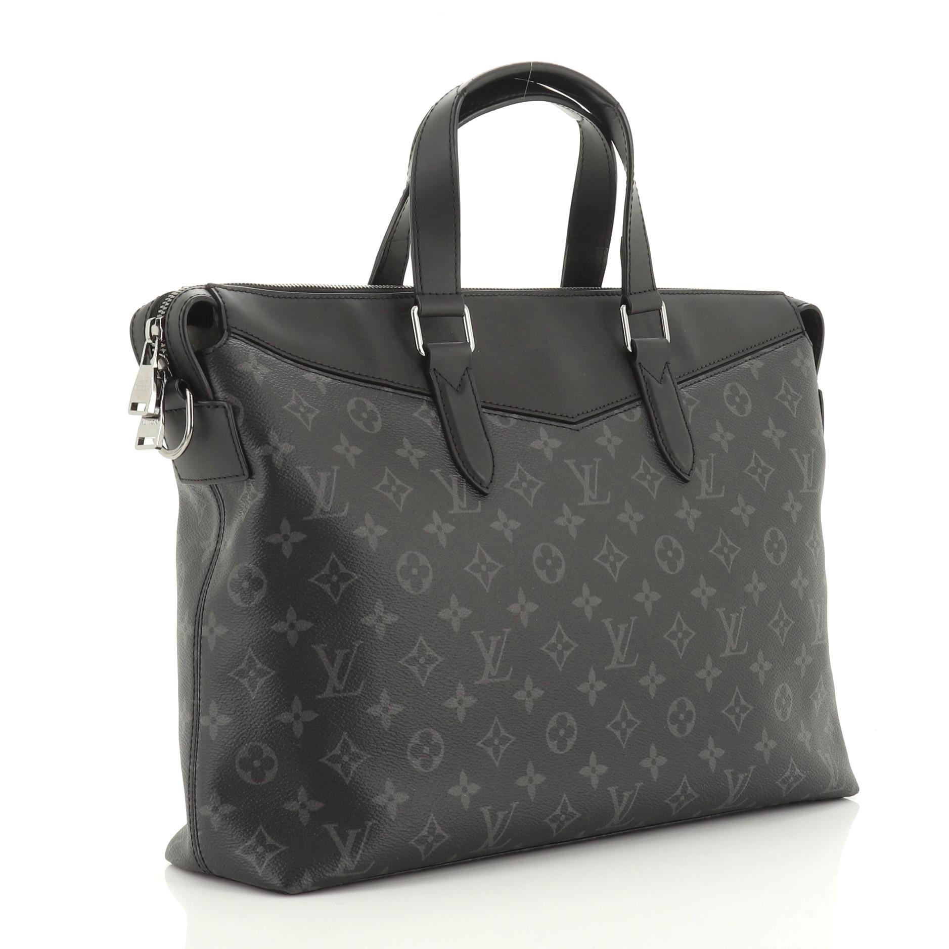 This Louis Vuitton Explorer Briefcase Monogram Eclipse Canvas, crafted in black eclipse monogram coated canvas, features dual-flat leather handles, adjustable shoulder strap, black leather trims, and gunmetal-tone hardware. Its zip closure opens to