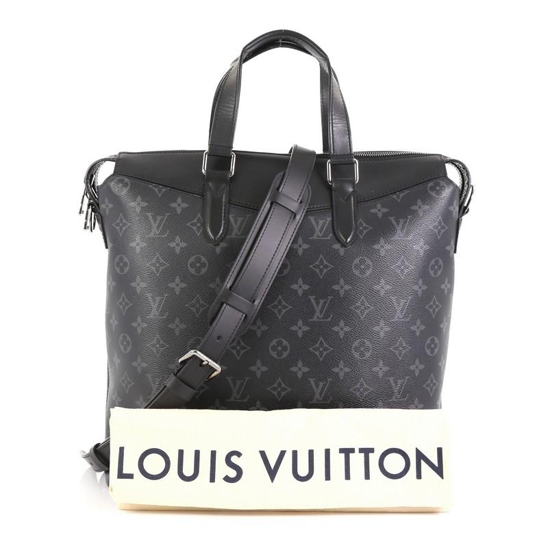 This Louis Vuitton Explorer Tote Monogram Eclipse Canvas, crafted from black monogram eclipse coated canvas, features dual leather handles and silver-tone hardware. Its zip closure opens to a black fabric interior with slip pockets. Authenticity