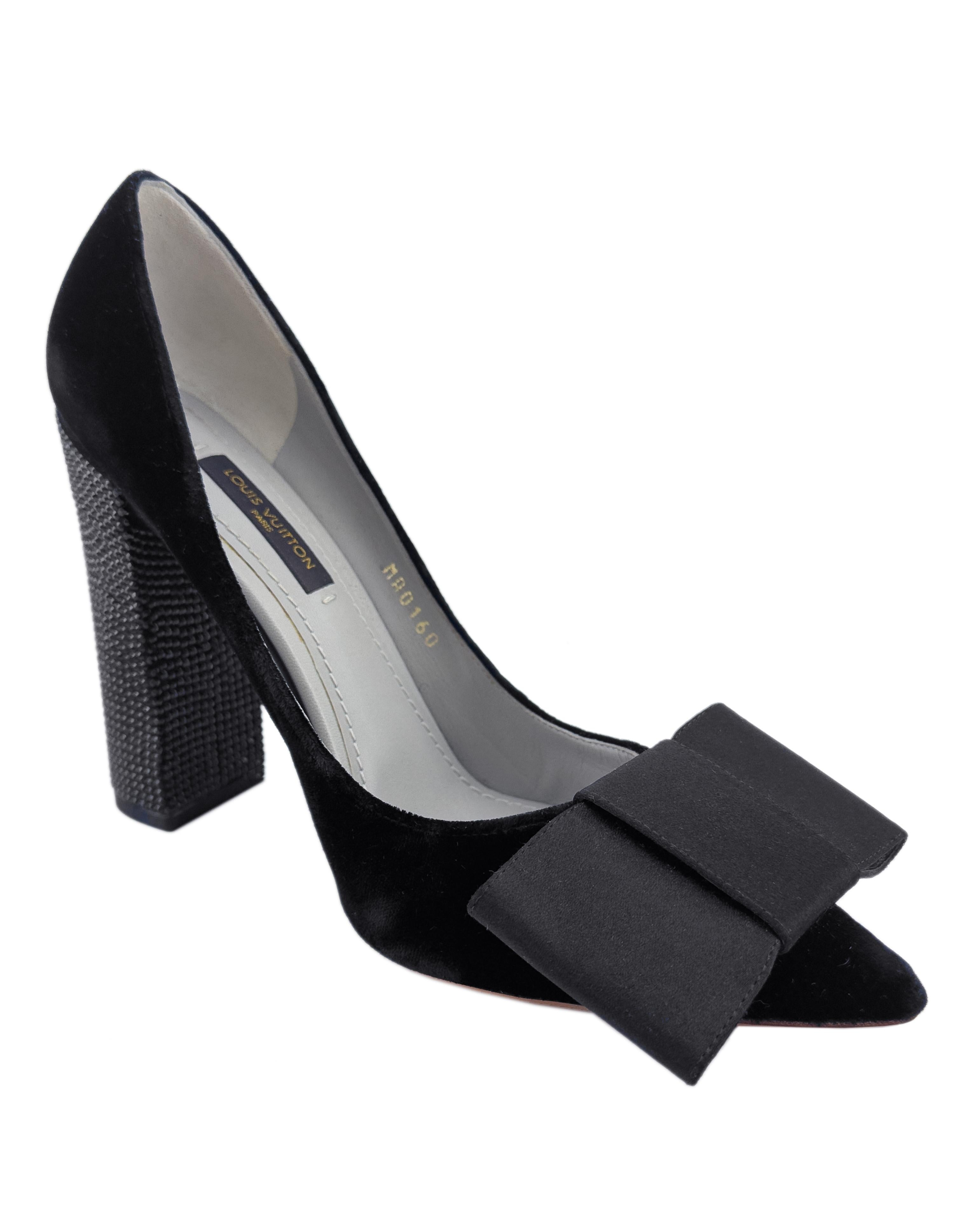 Shown on the runway of the Louis Vuitton 2010 Fall collection by Marc Jacobs. Black velvet Louis Vuitton Beauty pumps with pointed toes, oversized flat satin bow accents at upper front and tonal crystal covered heels. 4.75