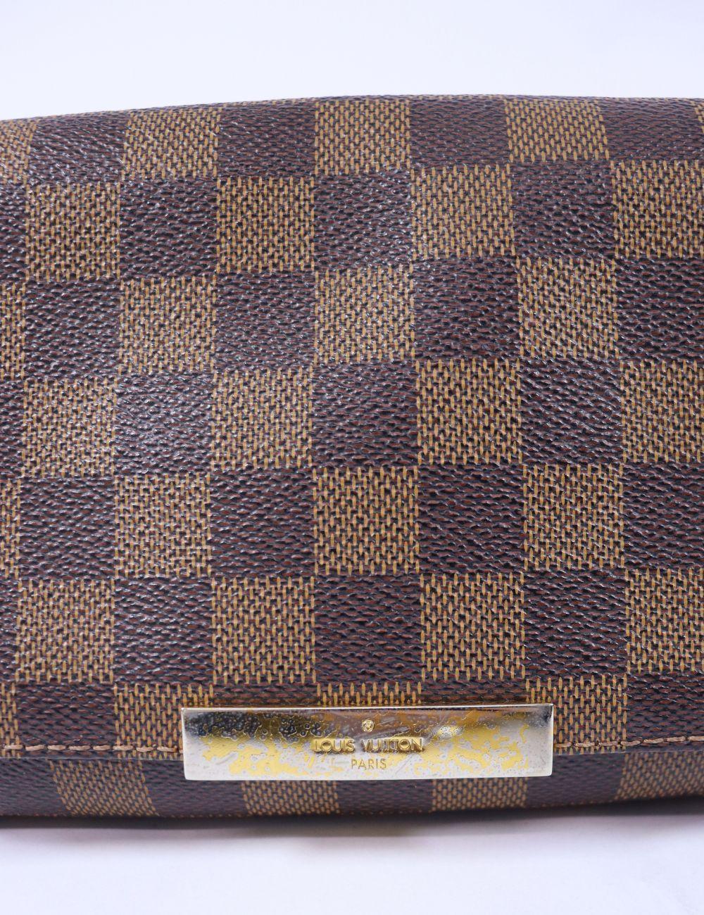 Classic meets contemporary in the Louis Vuitton Favorite MM—a coveted piece crafted in the brand’s iconic Damier Ebene canvas. This structured yet feminine flap bag features a magnetic closure, sleek gold-tone chain strap, and a detachable leather
