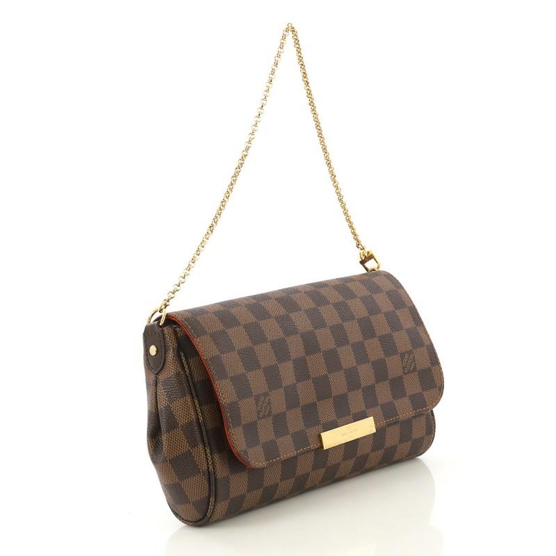 This Louis Vuitton Favorite Handbag Damier MM, crafted from brown damier ebene coated canvas, features a chain link strap and gold-tone hardware. Its hidden magnetic closure opens to a red fabric interior with side slip pocket. Authenticity code