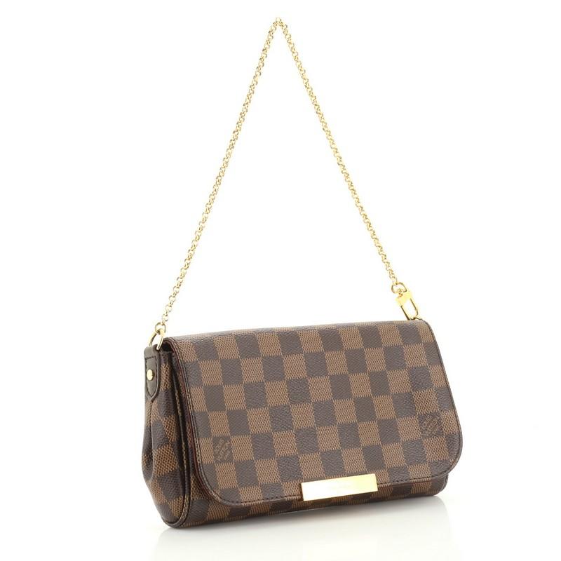 This Louis Vuitton Favorite Handbag Damier PM, crafted from damier ebene coated canvas, features a chain link strap and gold-tone hardware. Its hidden magnetic closure opens to a red fabric interior with side slip pocket. Authenticity code reads: