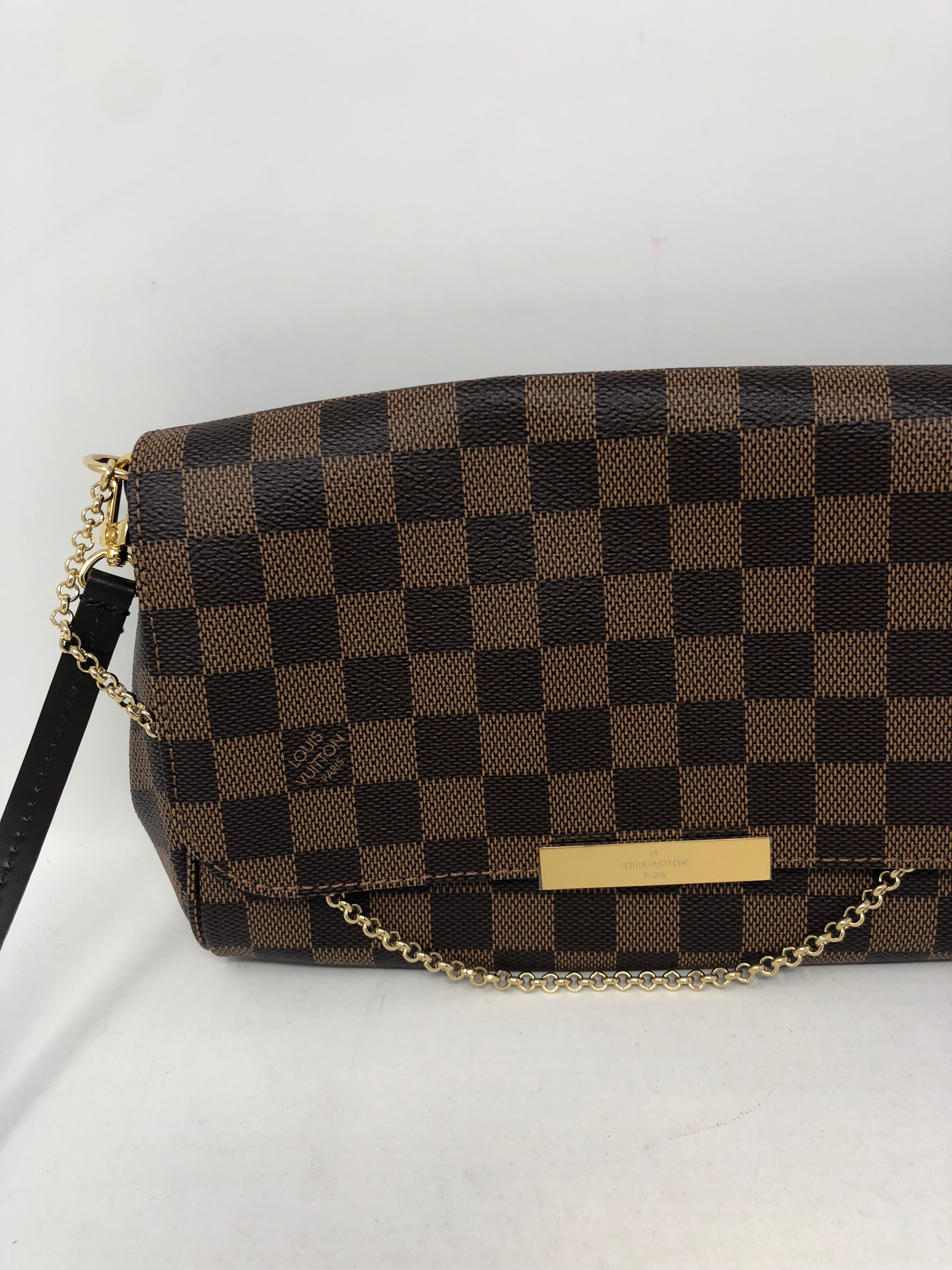 Louis Vuitton Favorite MM Damier Ebene Crossbody. Brand new and sold out at LV. This one includes dust cover and box. Plastic still on gold hardware. The perfect gift. Guaranteed authentic. 