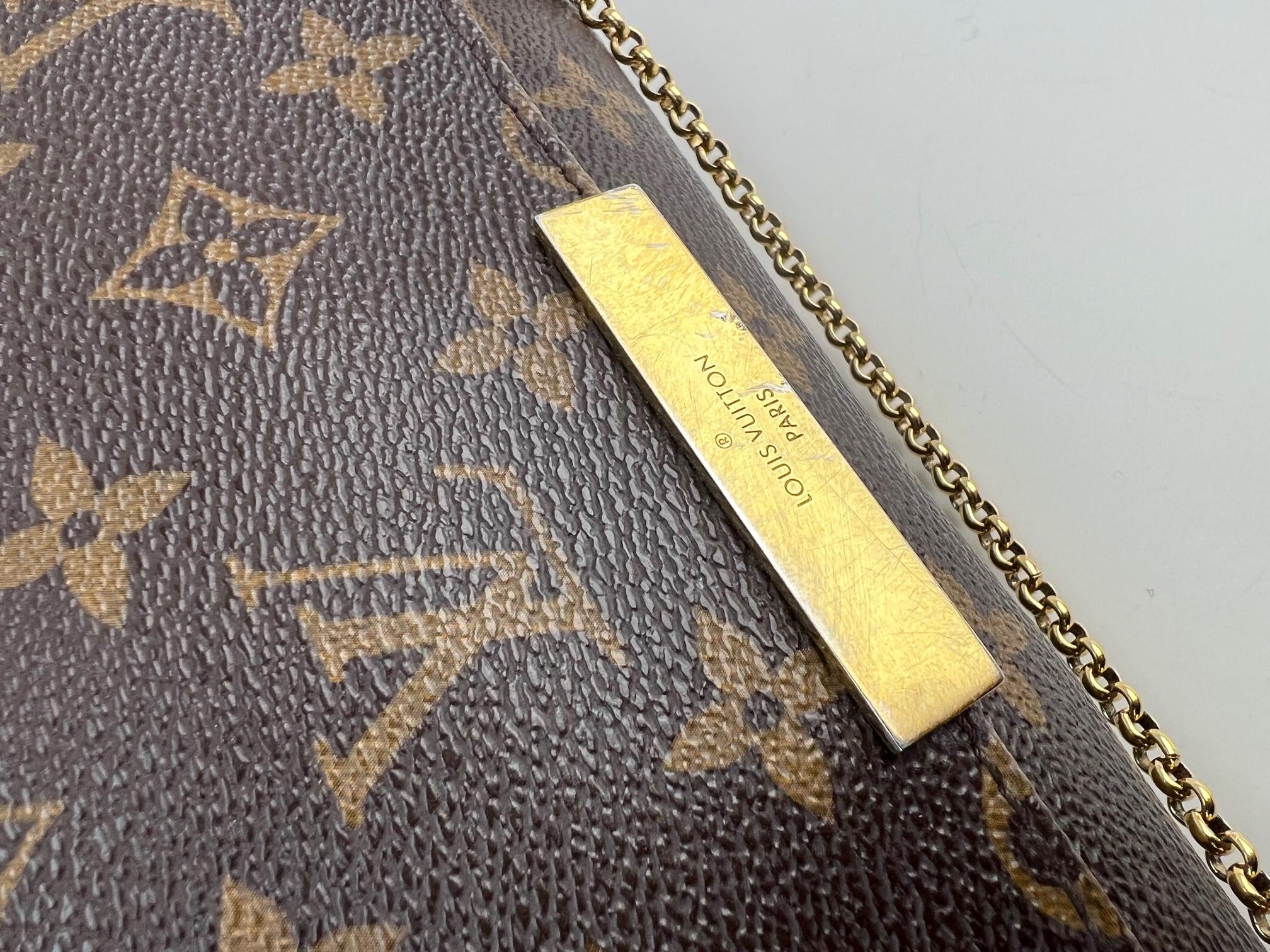 Louis Vuitton Favorite MM Monogram
M40718
100% Authentic  Pre-Owned 
RATING: B.. good, shows minor signs of wear
MATERIAL: monogram canvas, metal, leather
STRAP: LV Leather w/ 1 Claw Hook, has some
marks 
DROP: 21''
HANDLE: golden chain only 1 side