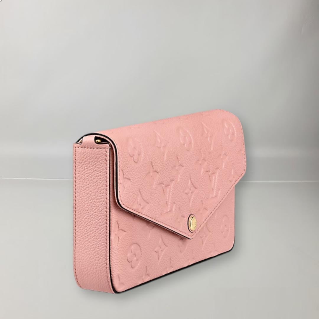  This Félicie clutch in Monogram Empreinte leather features embossed Louis Vuitton's iconic Monogram motif. The envelope-style design features two removable inner coin pockets and a removable gold-tone chain. It can be carried on the shoulder or as