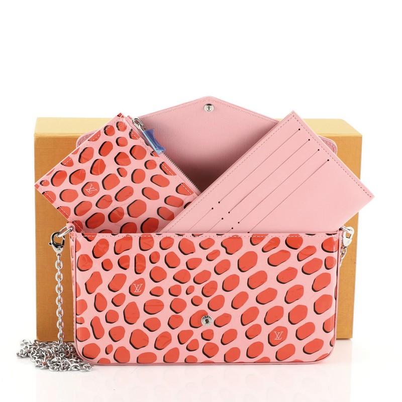 This Louis Vuitton Felicie Pochette Limited Edition Monogram Vernis, crafted from pink and red monogram vernis leather, features detachable chain-link strap, ‘Jungle Dots’ print, and silver-tone hardware. Its press stud closure opens to a pink