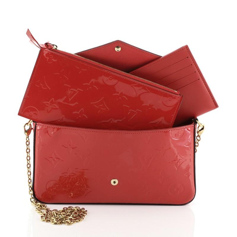 This Louis Vuitton Felicie Pochette Monogram Vernis, crafted from red patent leather, features detachable chain link strap and gold-tone hardware. Its press stud closure opens to a red fabric interior. Authenticity code reads: MI5115. 

Estimated