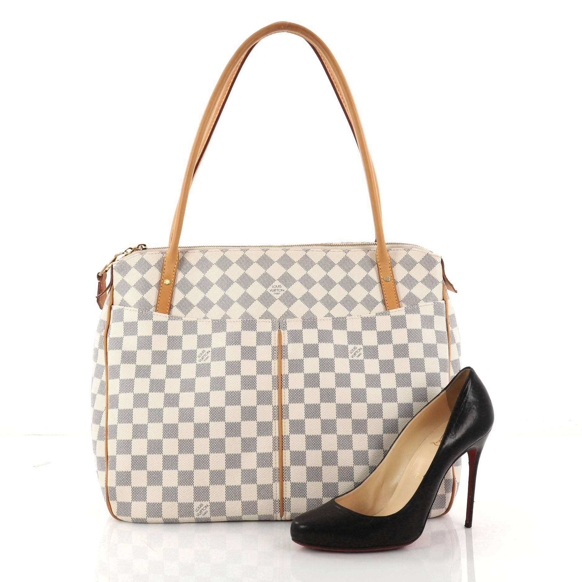 This authentic Louis Vuitton Figheri Handbag Damier GM is a modern yet elegant accessory made for everyday excursions. Crafted in popular damier azur coated canvas, this functional tote features long dual-rolled handles, vachetta leather trims,