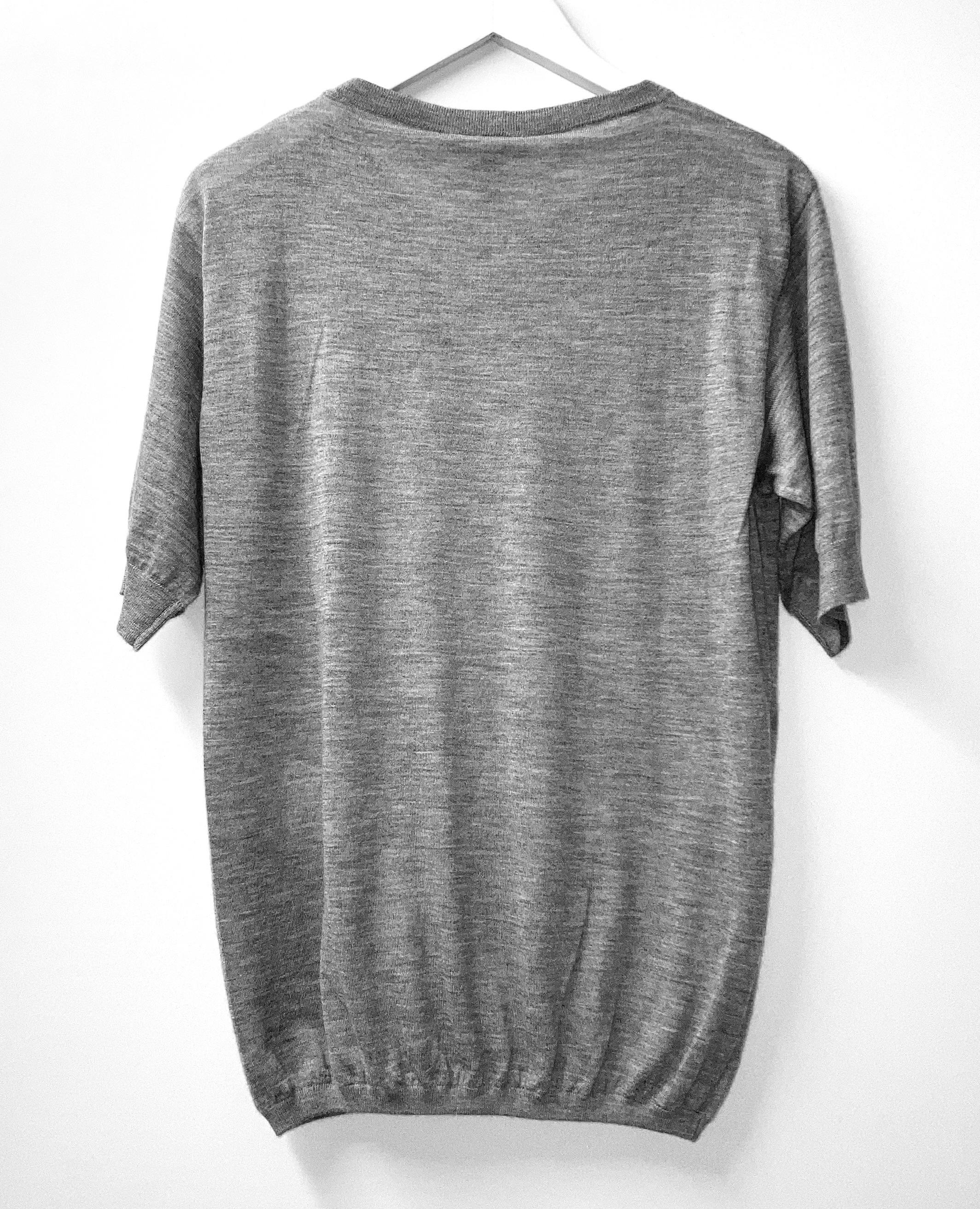 Super luxe short sleeve cashmere sweater from Louis Vuitton - bought for £750 and new with tag. Made from super soft, fine grey marled cashmere with 1% polyamide and elastane. It has ruched ribbed hem, gold LV plaque and rounded neckline. Size XS