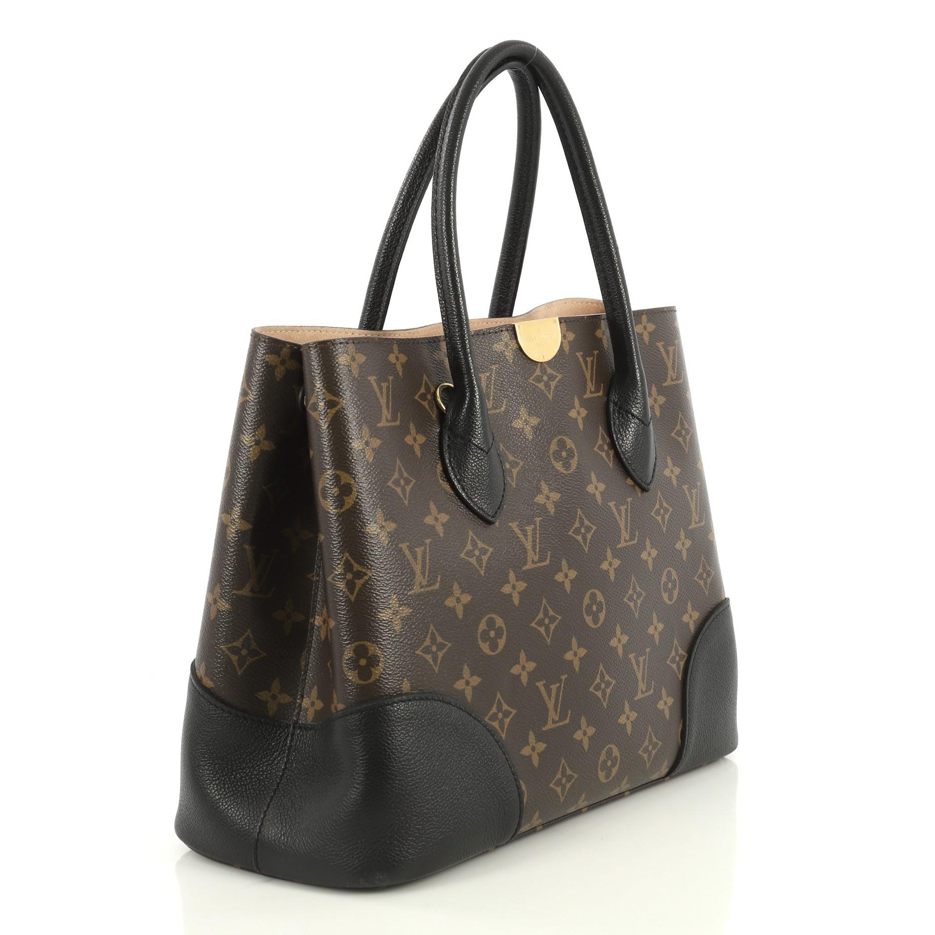 This Louis Vuitton Flandrin Handbag Monogram Canvas, crafted from brown monogram coated canvas, features dual rolled leather handles and gold-tone hardware. It opens to a neutral microfiber interior with a center zip compartment. Authenticity code