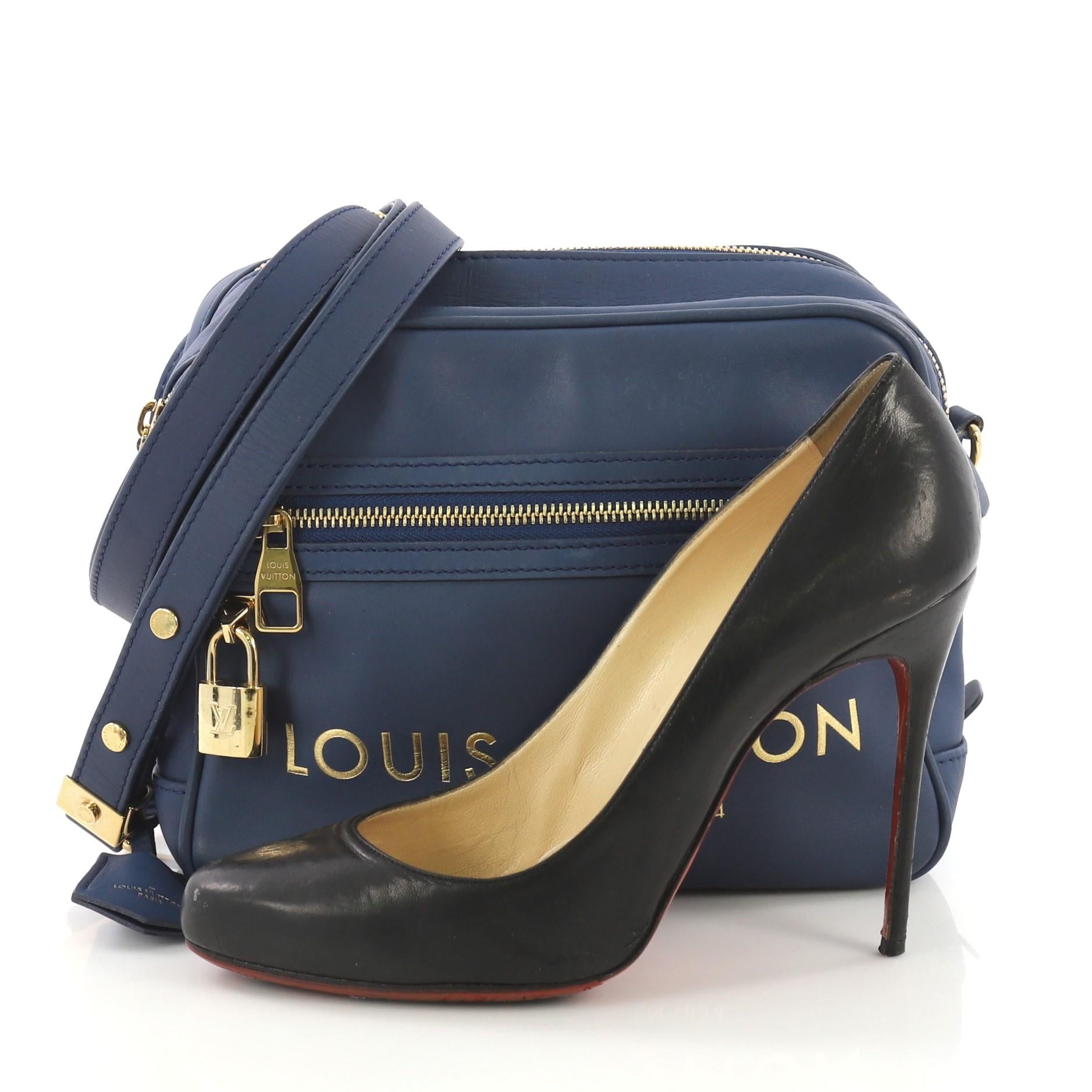 This Louis Vuitton Flight Paname Takeoff Bag Leather, crafted in blue leather, features flat adjustable shoulder strap, exterior front zip pocket and back slip pocket, dual zip compartments, and gold-tone hardware. Its zip closure opens to a beige