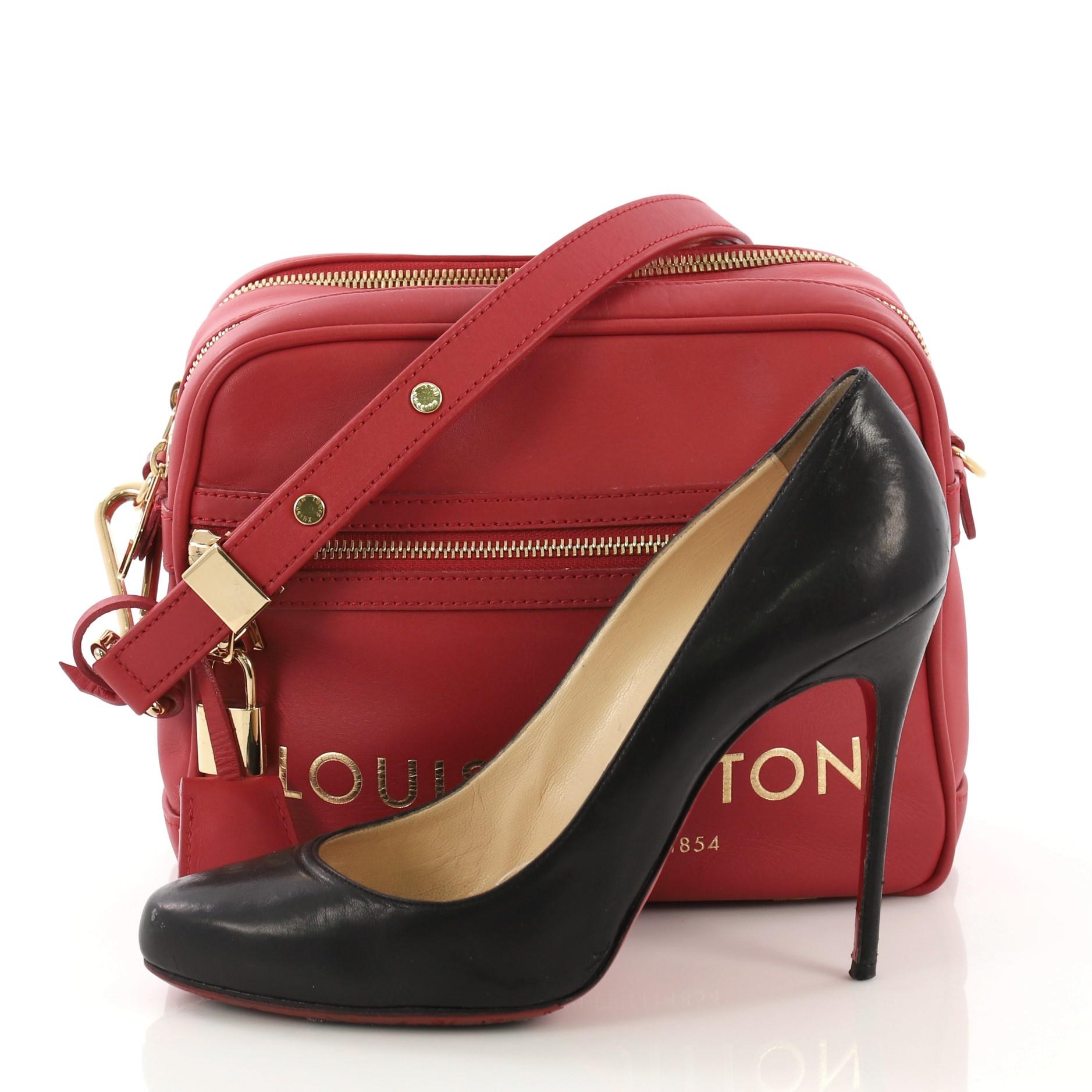 This Louis Vuitton Flight Paname Takeoff Bag Leather, crafted in red leather, features flat adjustable shoulder strap, exterior front zip pocket and back slip pocket, dual zip compartments, and gold-tone hardware. Its zip closure opens to a beige