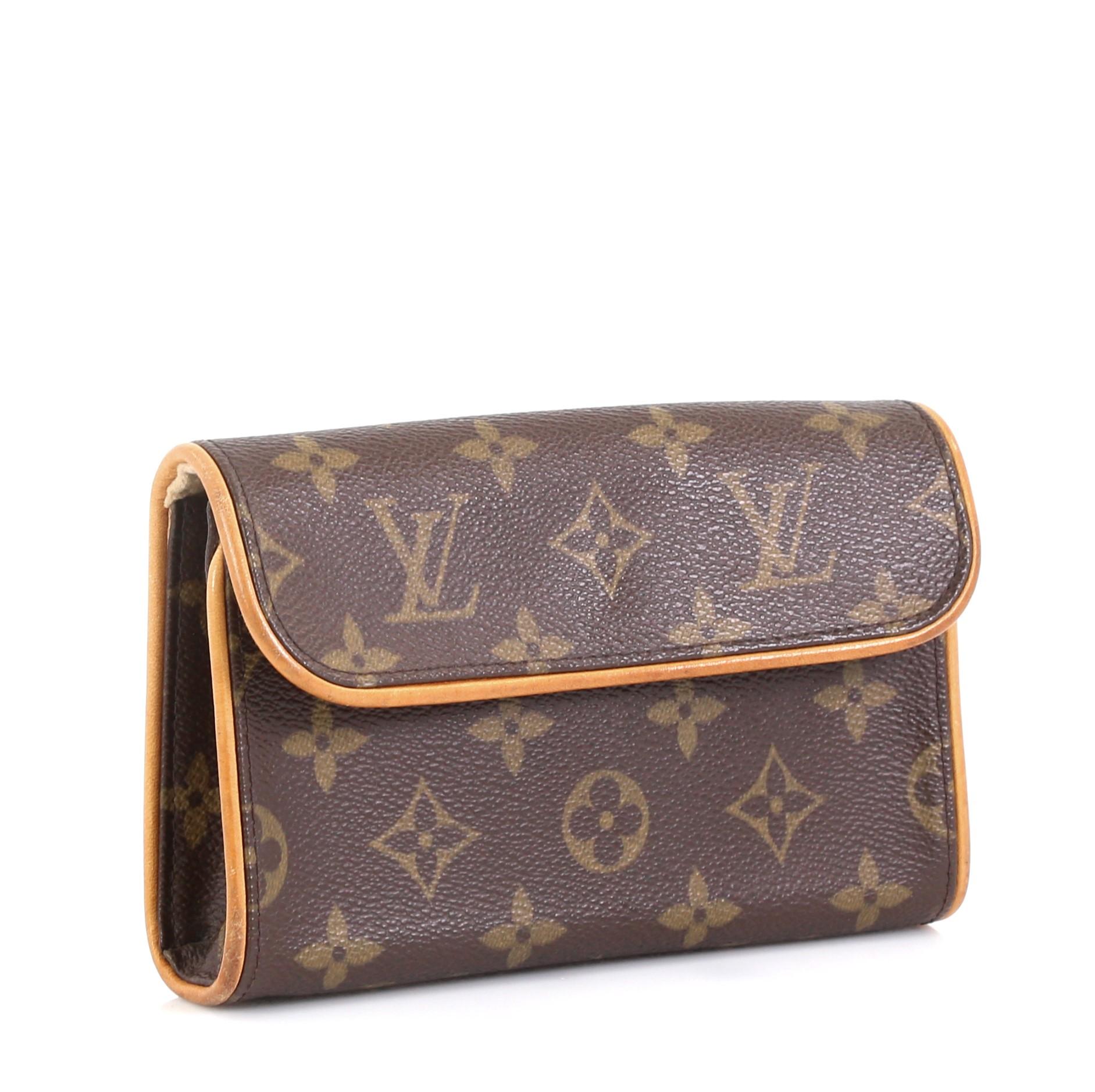 This Louis Vuitton Florentine Pochette Monogram Canvas, crafted from brown monogram coated canvas, features an adjustable leather snap fastener belt and gold-tone hardware. Its flap with magnetic closure opens to a neutral microfiber interior.