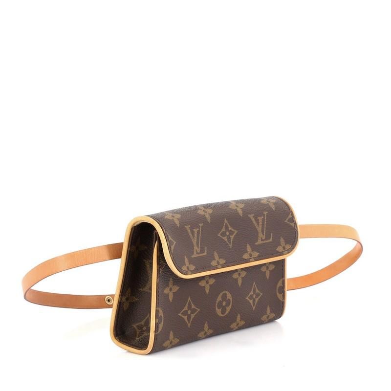 This Louis Vuitton Florentine Pochette Monogram Canvas, crafted from brown monogram coated canvas, features an adjustable leather snap fastener belt and gold-tone hardware. Its flap with magnetic closure opens to a neutral microfiber interior.