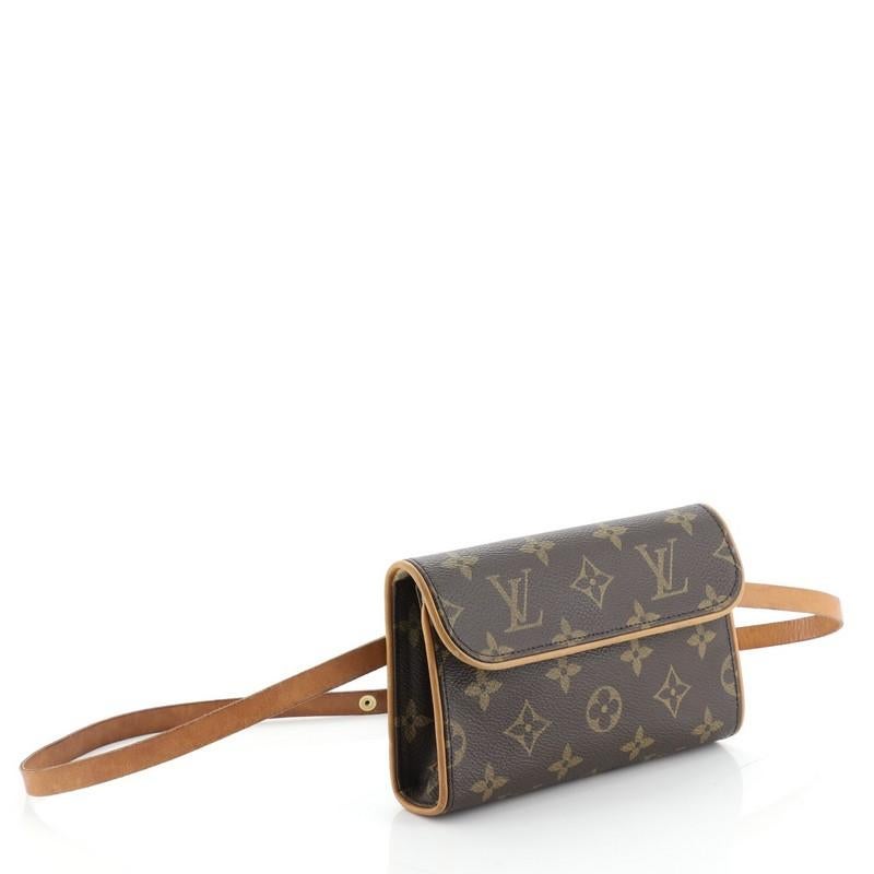 This Louis Vuitton Florentine Pochette Monogram Canvas, crafted from brown monogram coated canvas, features an adjustable leather snap fastener belt and gold-tone hardware. Its flap with magnetic closure opens to a neutral microfiber interior.