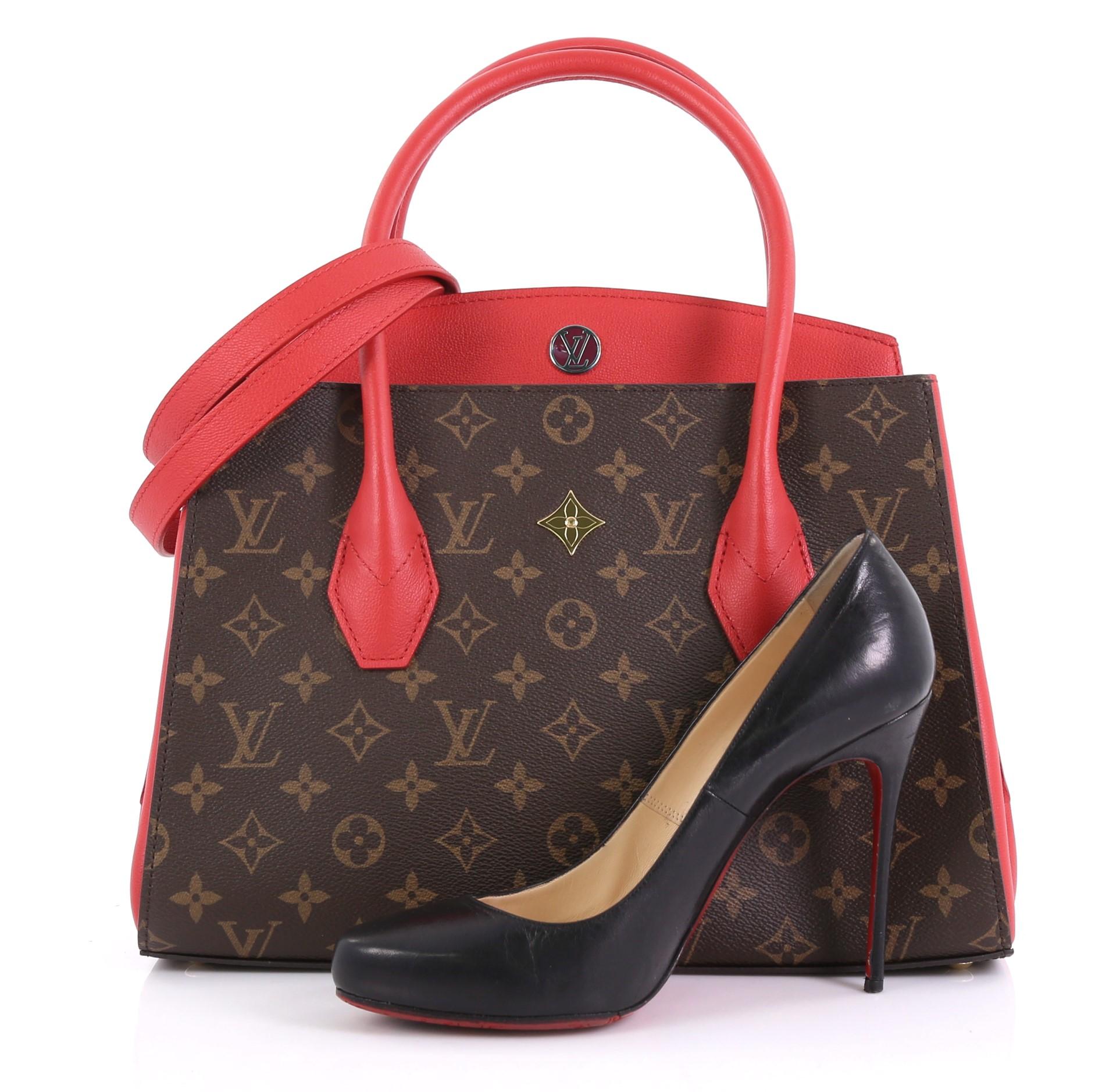 This Louis Vuitton Florine Handbag Monogram Canvas and Leather, crafted in brown monogram coated canvas, features dual rolled leather handles, red calf leather trim, LV logo at front, and gold-tone hardware. It opens to a red microfiber interior