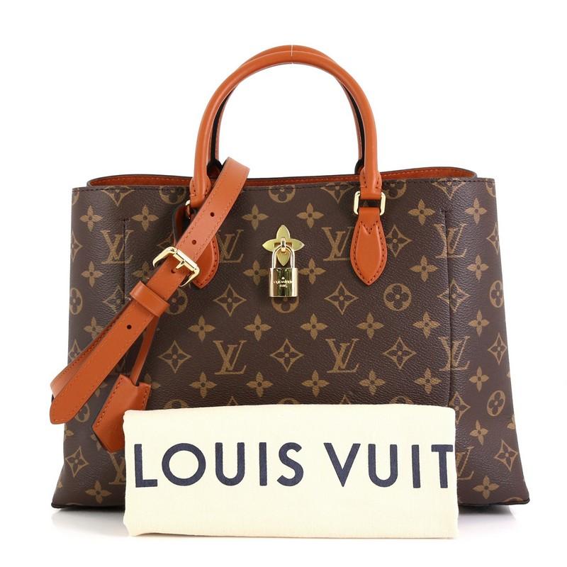 This Louis Vuitton Flower Tote Monogram Canvas, crafted in brown monogram coated canvas, features dual rolled leather handles, monogram flower padlock, and gold-tone hardware. It opens to a brown microfiber interior with a center zip compartment and