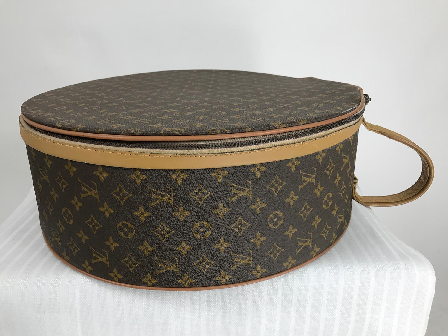 Louis Vuitton for The French Company, also labeled Saks Fifth Ave. 50cm Boite Chapeaux, round hat box. In remarkably good condition for it's age and use. Louis Vuitton logo canvas with leather welt cord and trimming outlining the zipper. Oval