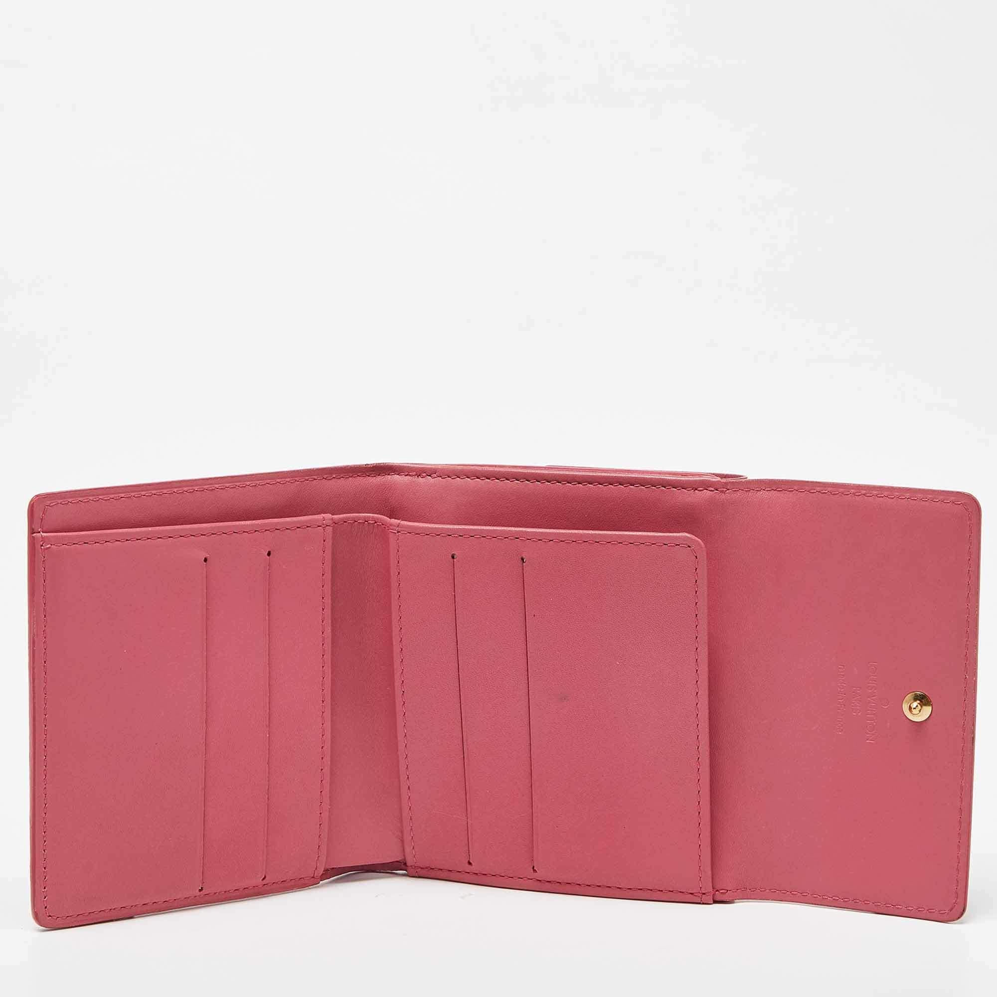 The well known and coveted monogram print is showcased on this Vernis Elise Wallet by Louis Vuitton. This small wallet will hold a lot more than you think It has a compartmentalized interior and this wallet is enclosed with a press stud flap closure.