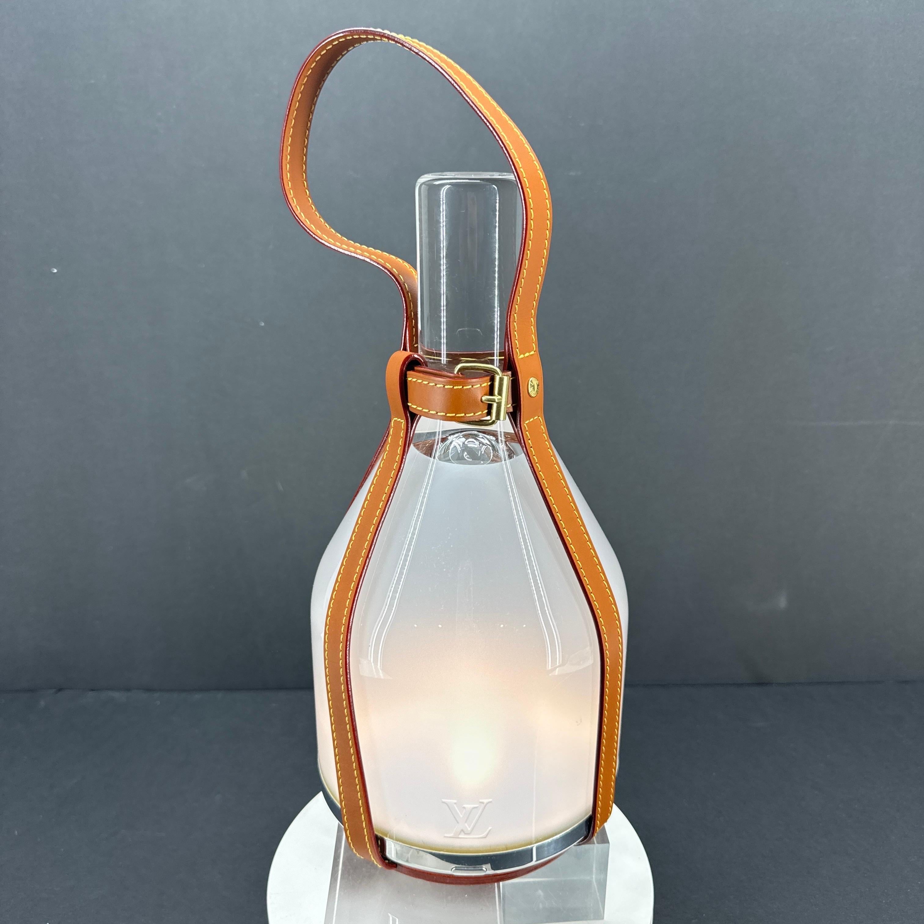 LV Bell Table Lamp in Frosted and Clear Glass with Caramel Leather Straps by Louis Vuitton, France.

Designers Edward Barber and Jay Osgerby have combined modern and traditional in this fantastic table lamp from Louis Vuitton. There is 30 hours of