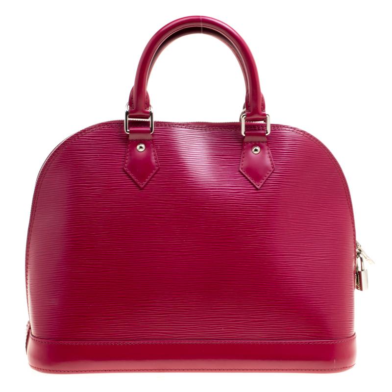 A classic from the house of Louis Vuitton, the shape of the Alma stands out. Louis Vuitton Alma was named after the Alma Bridge that connects Paris's fashionable neighborhood. Made from signature Epi leather the bag features a beautiful fuchsia