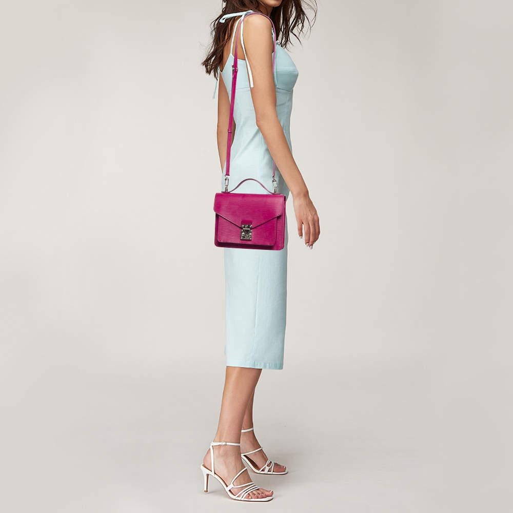 Set in a beautiful fuchsia color this Louis Vuitton Monceau BB bag is pure perfection. It is designed with Epi leather and complemented by silver tone hardware and the signature lock closure. Its top handle is coupled with a detachable shoulder