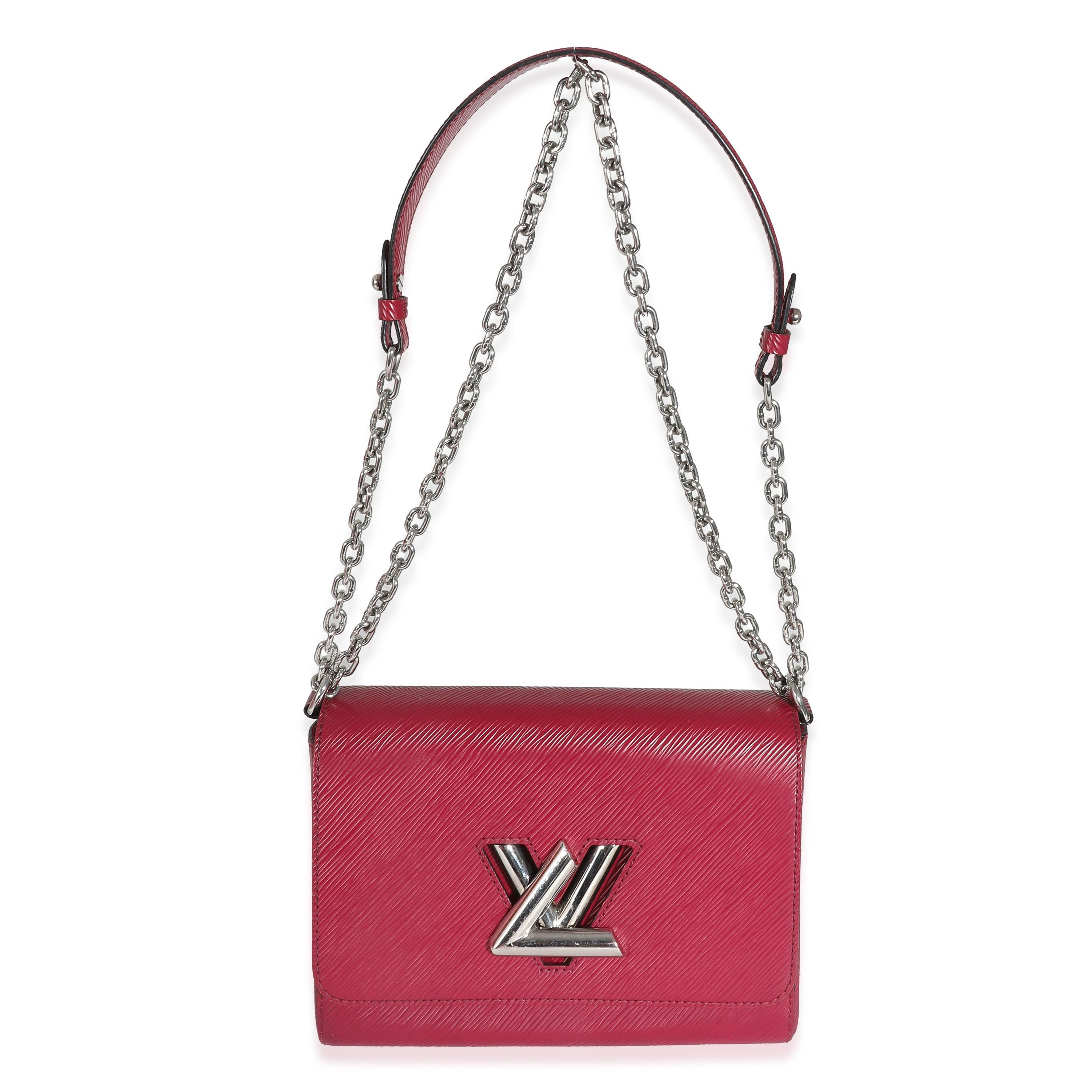 Listing Title: Louis Vuitton Fuchsia Epi Twist MM
SKU: 137241
Condition: Pre-owned 
Condition Description: The Louis Vuitton Twist collection was unveiled in 2015. The accessory features a chunky monogram logo on the front for a contemporary