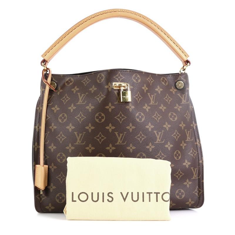 This Louis Vuitton Gaia Handbag Monogram Canvas, crafted from brown monogram coated canvas, features a natural cowhide rolled handle, leather side gussets, and gold-tone hardware. Its wide open top showcases a black microfiber interior with slip