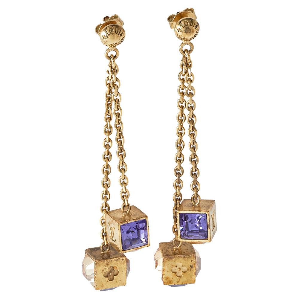 Crafted using gold-tone metal, the fashion essence of these Louis Vuitton earrings is unmatched. The look is further elevated by the crystal-embedded dangling cubes. They will surely shine when worn with off-shoulder dresses.

Includes:Original Box,
