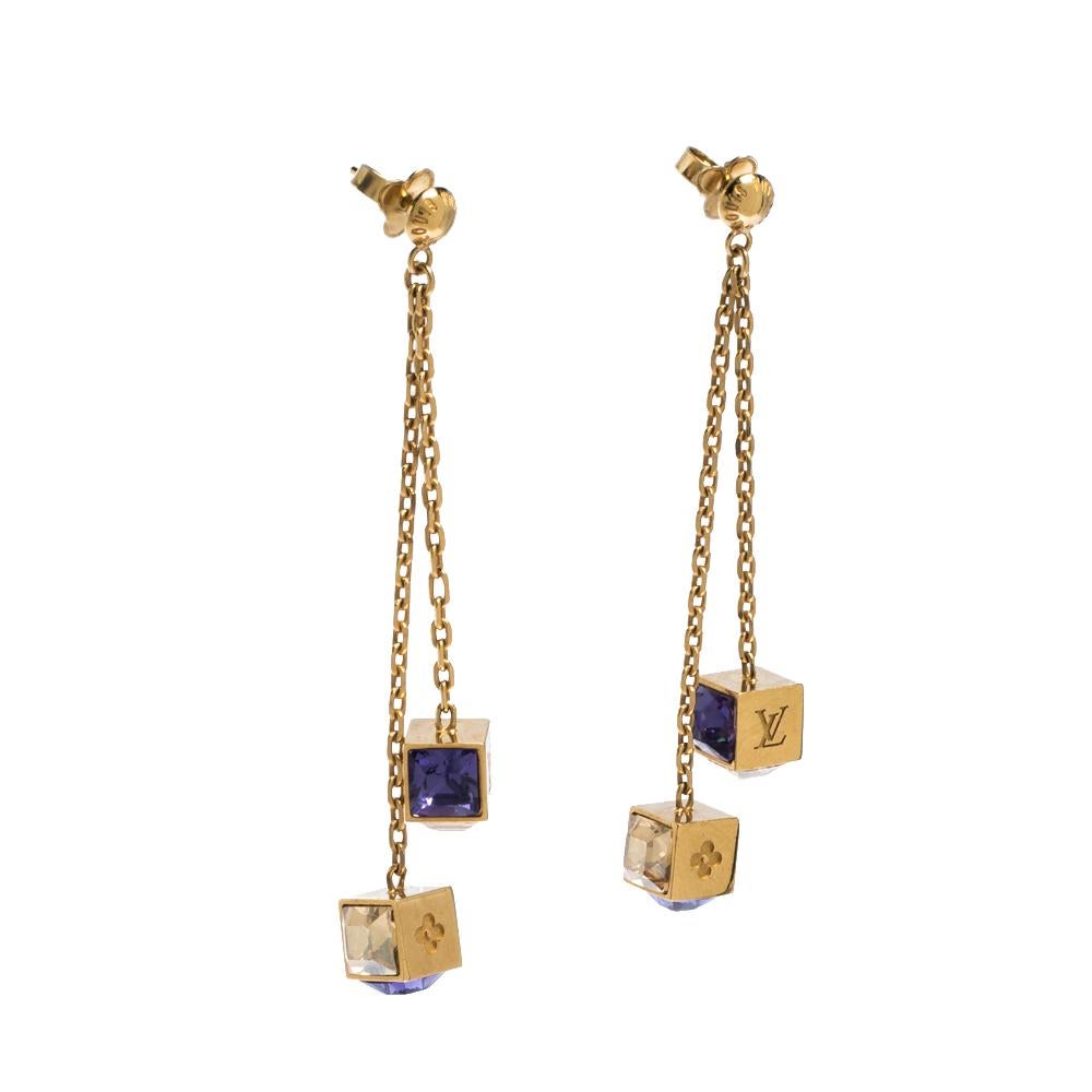 Crafted using gold-tone metal, the fashion essence of these Louis Vuitton earrings is unmatched. The look is further elevated by the crystal-embedded dangling cubes. They will surely shine when worn with off-shoulder dresses.

