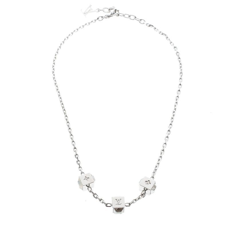 Artfully made from silver-tone metal, this flawless necklace by Louis Vuitton can be your next prized possession. Featuring a gorgeous set of 3 cubes with monogram engravings and crystals, the design has been finished with the signature LV logo and