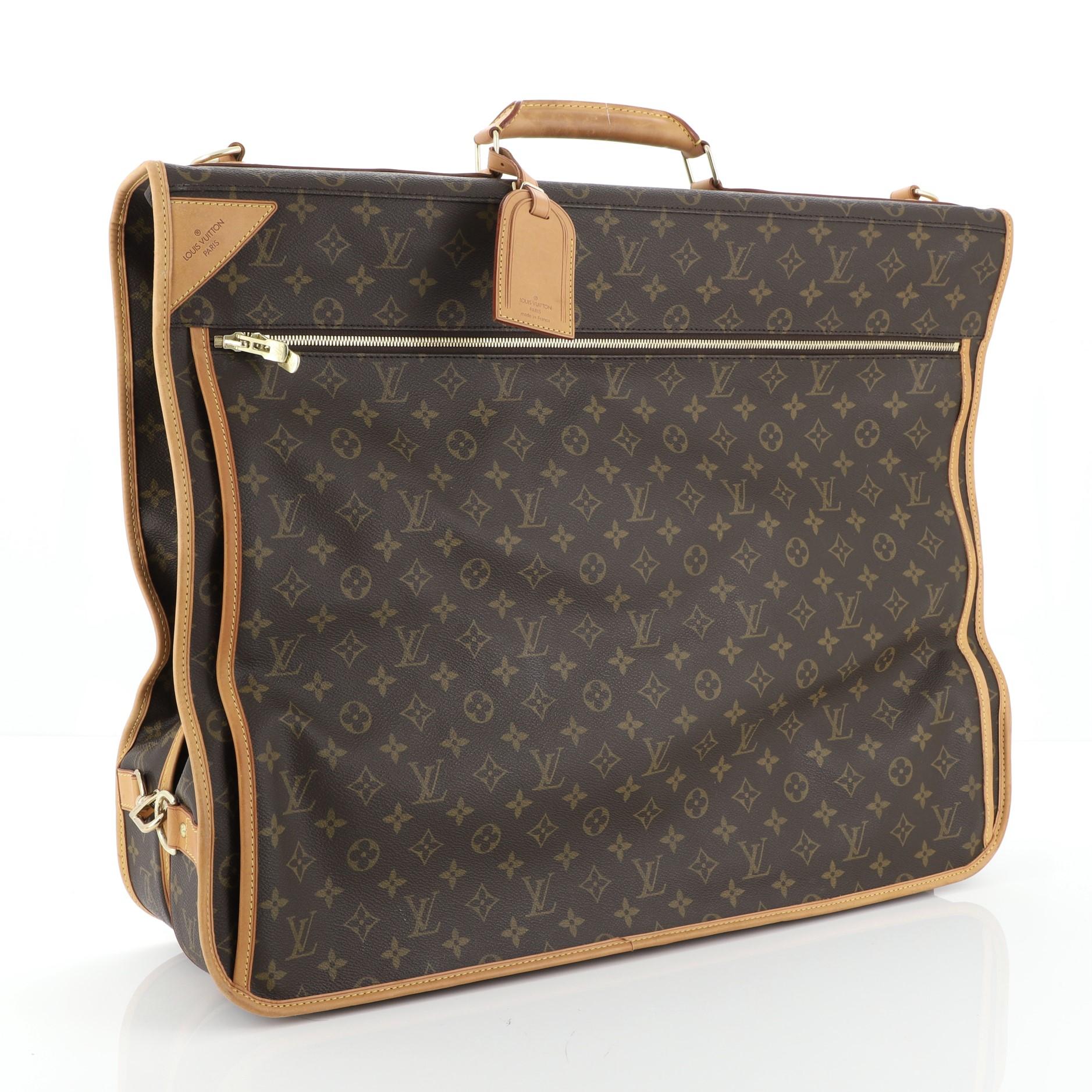 This Louis Vuitton Garment Carrier Bag Monogram Canvas Two Hangers, crafted in brown monogram coated canvas, features a flat silhouette with front zipped exterior compartments, side lock closures to keep the bag compact, top handle, gold hook at its