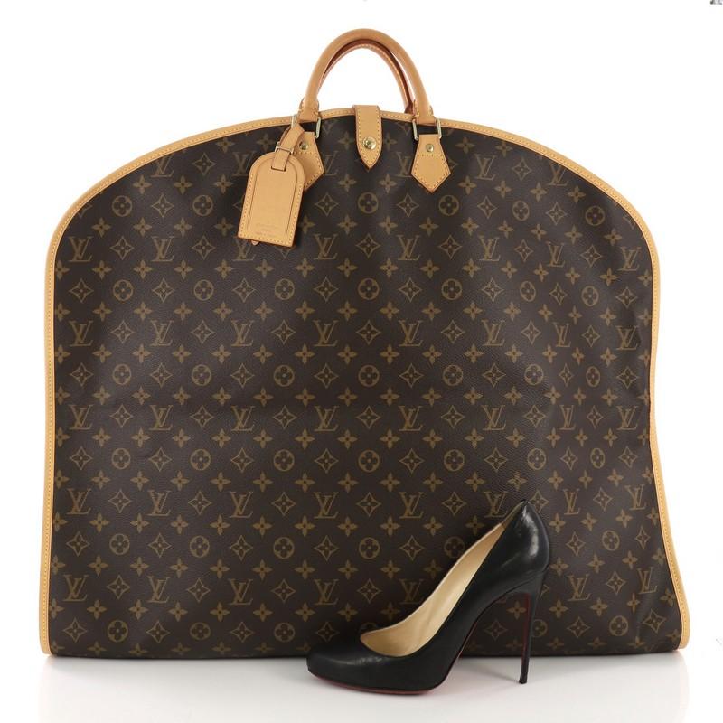 This Louis Vuitton Garment Cover Monogram Canvas, crafted in brown monogram coated canvas, features dual rolled leather top handles, vachetta leather piping and trims, garment cover hook with leather closure, and gold-tone hardware. Its zip closure