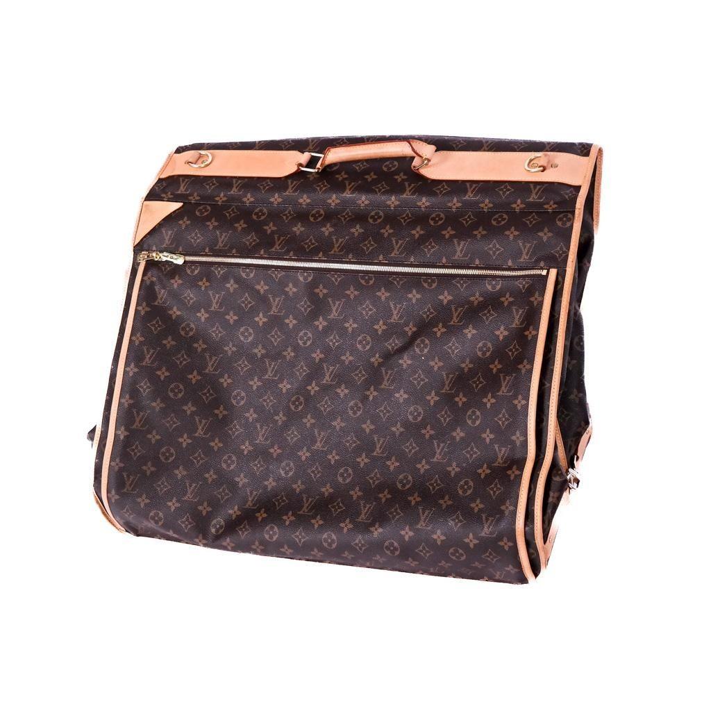 Vintage Louis Vuitton monogram garment bag represents the epitome of luxury travel and refined style. The exterior of the bag is adorned with the renowned LV monogram and vachetta leather details. Includes zippered compartments and pockets
