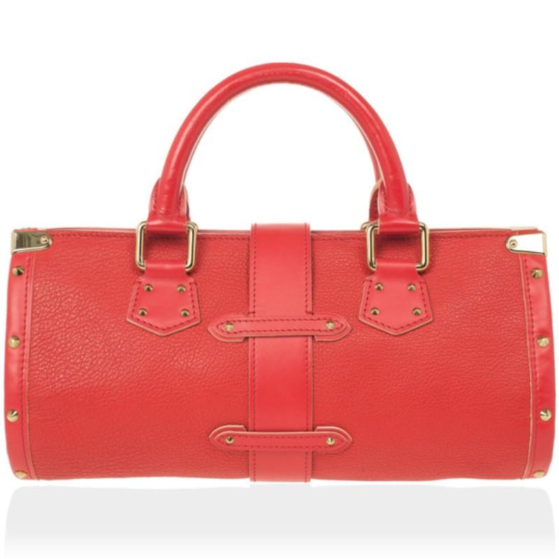 Look simply stunning with this Louis Vuitton Geranium Suhali Leather L'Epanoui PM Bag on your shoulder. This tote is made from red goat leather and accented with gold-tone studs and a logo-engraved push-lock closure flap. This bag comes with double