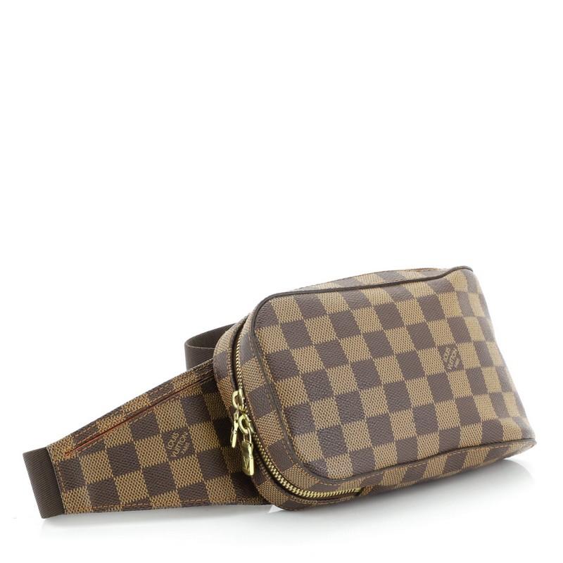 This Louis Vuitton Geronimos Waist Bag Damier, crafted from damier ebene coated canvas, features an adjustable brown canvas belt strap and gold-tone hardware. Its zip closure opens to an orange fabric interior. Authenticity code reads: CA0013.